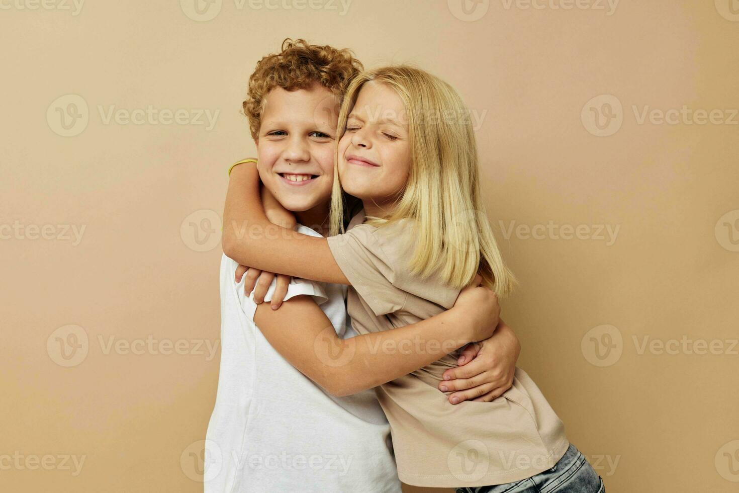 boy and girl in t-shirts hugs beige background friendship photo