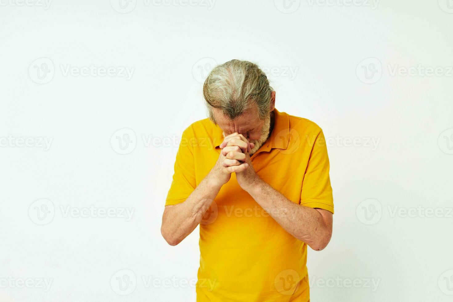 Photo of retired old man with a gray beard emotion gestures hands light background