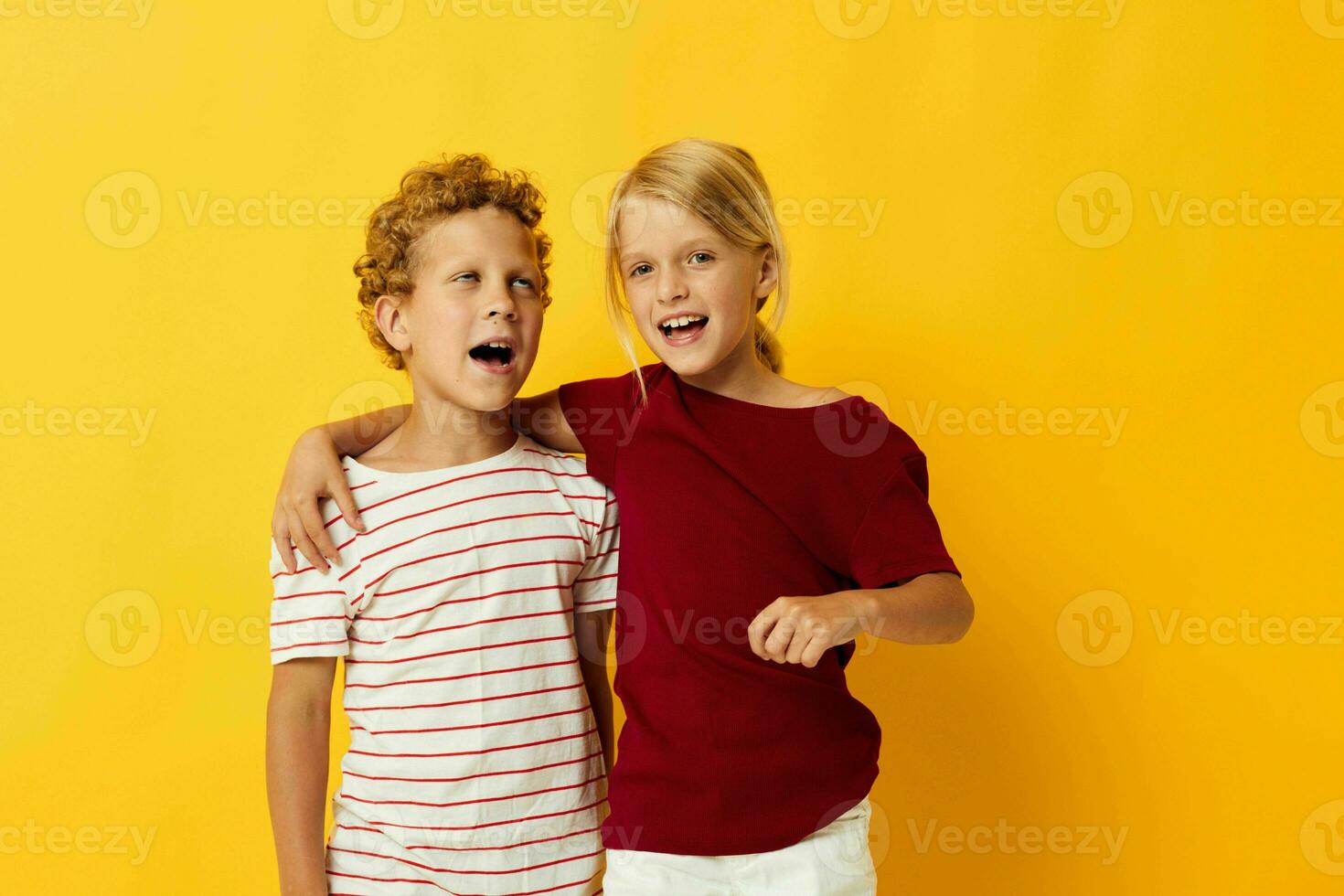 Cute preschool kids cuddling fashion childhood entertainment on colored background photo
