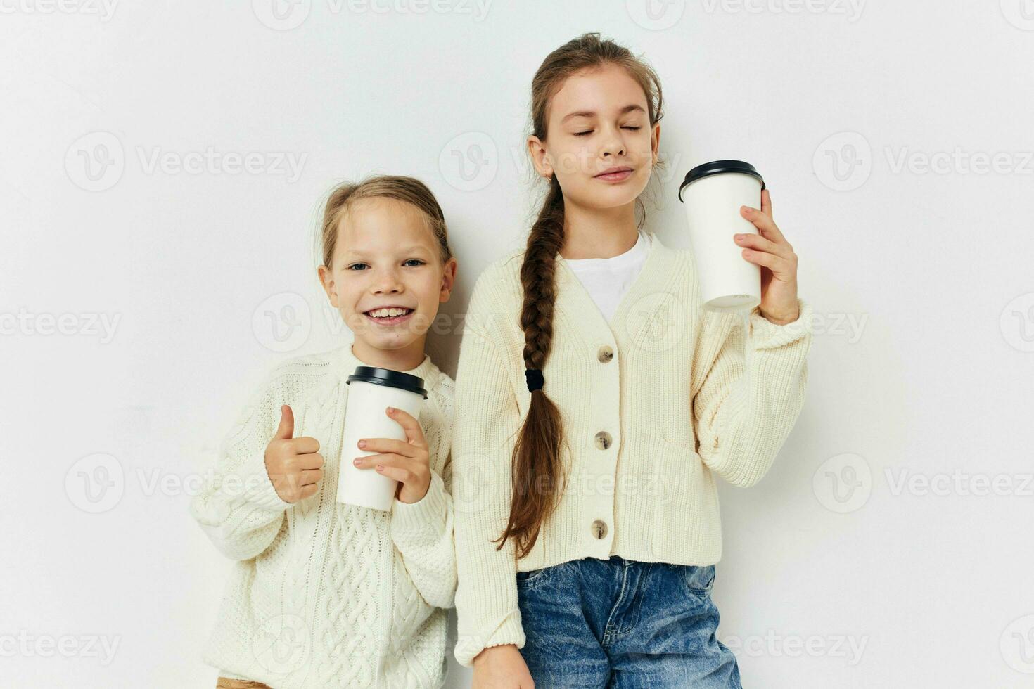 two little girls friends with glasses in their hands photo