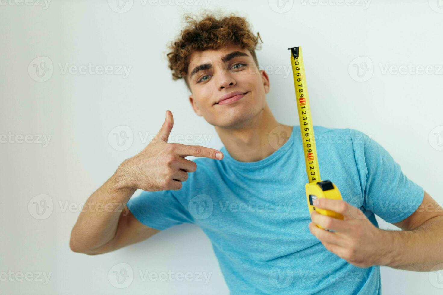 handsome guy blue t-shirt measuring tape posing Lifestyle unaltered photo
