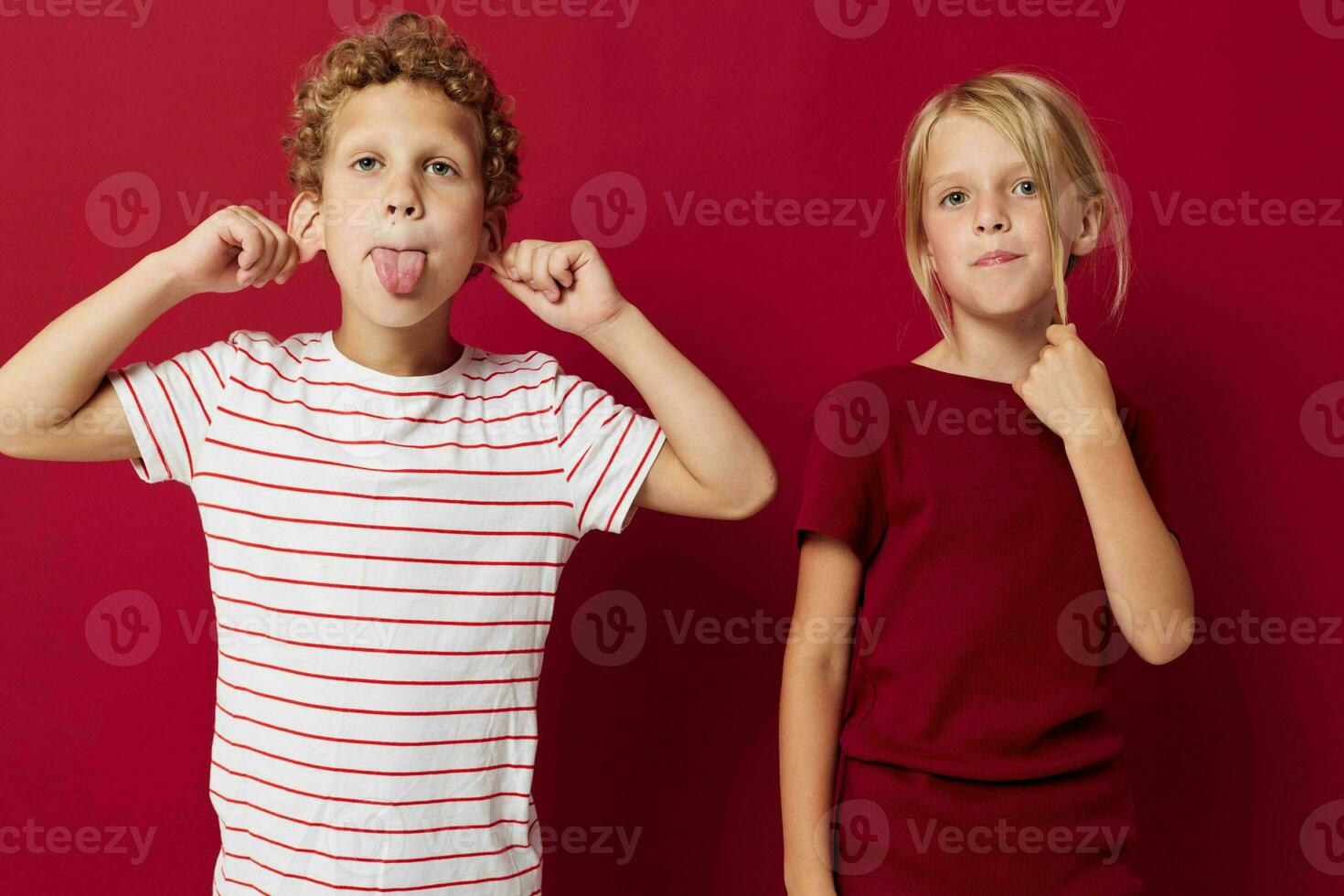 Portrait of cute children good mood standing next to posing on colored background photo