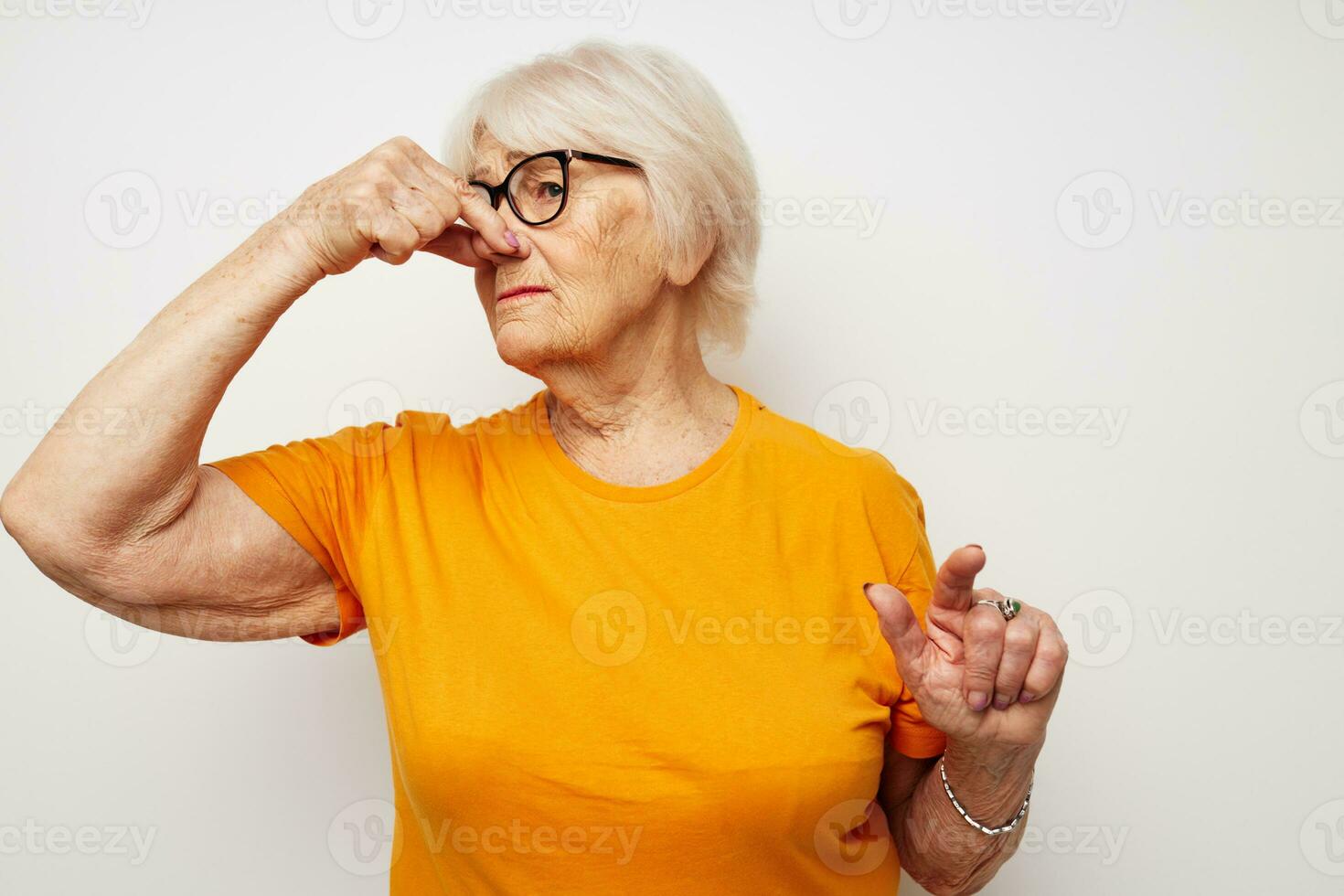 Photo of retired old lady in casual t-shirt and glasses close-up