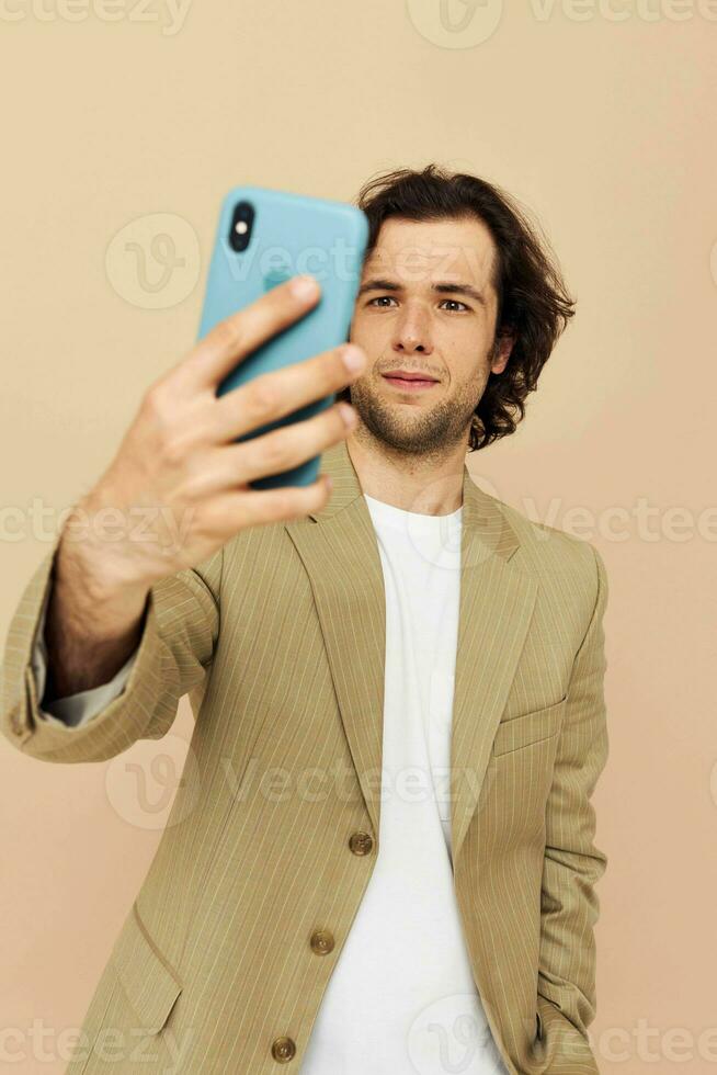 Attractive man takes a selfie classic style technologies isolated background photo