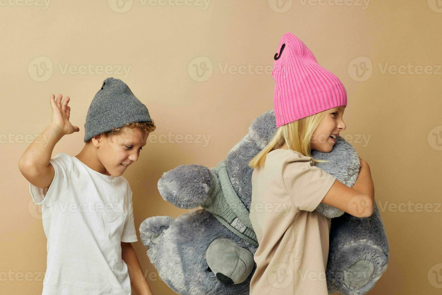 Little boy and girl in hats with a teddy bear friendship Lifestyle unaltered photo