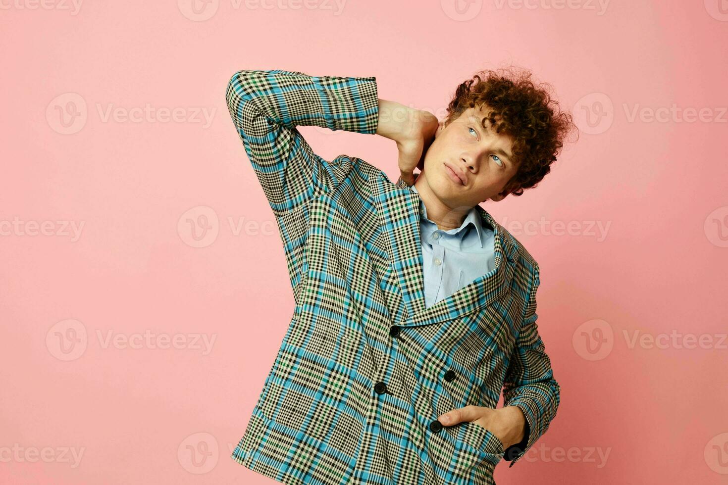 cute red-haired guy in a suit business look posing emotions pink background unaltered photo