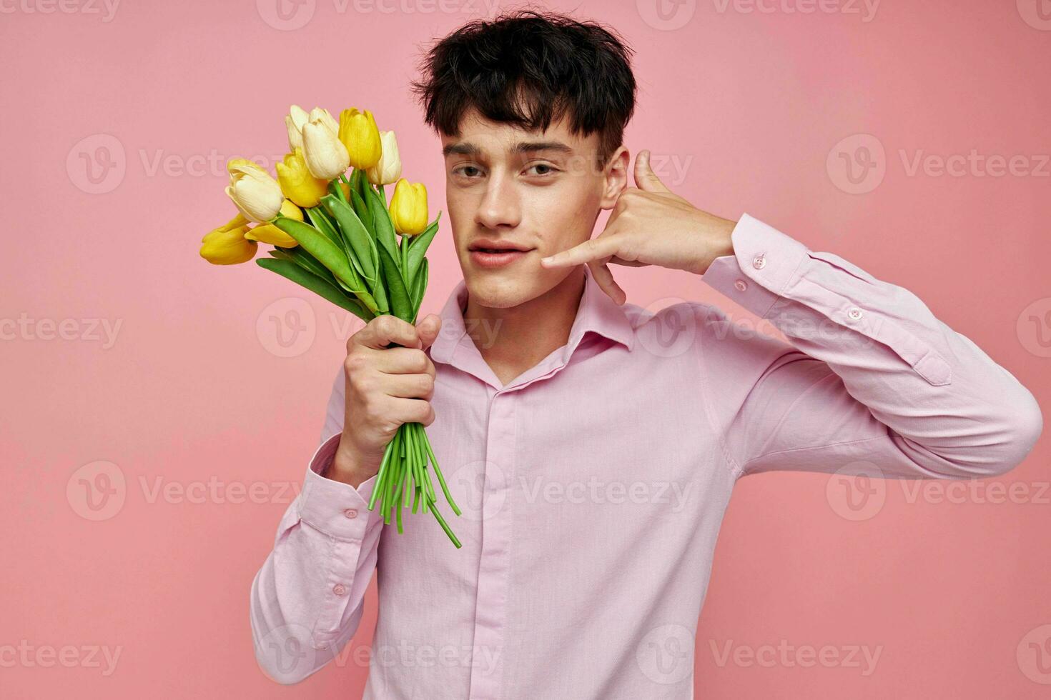 portrait of a young man bouquet of flowers date romance posing pink