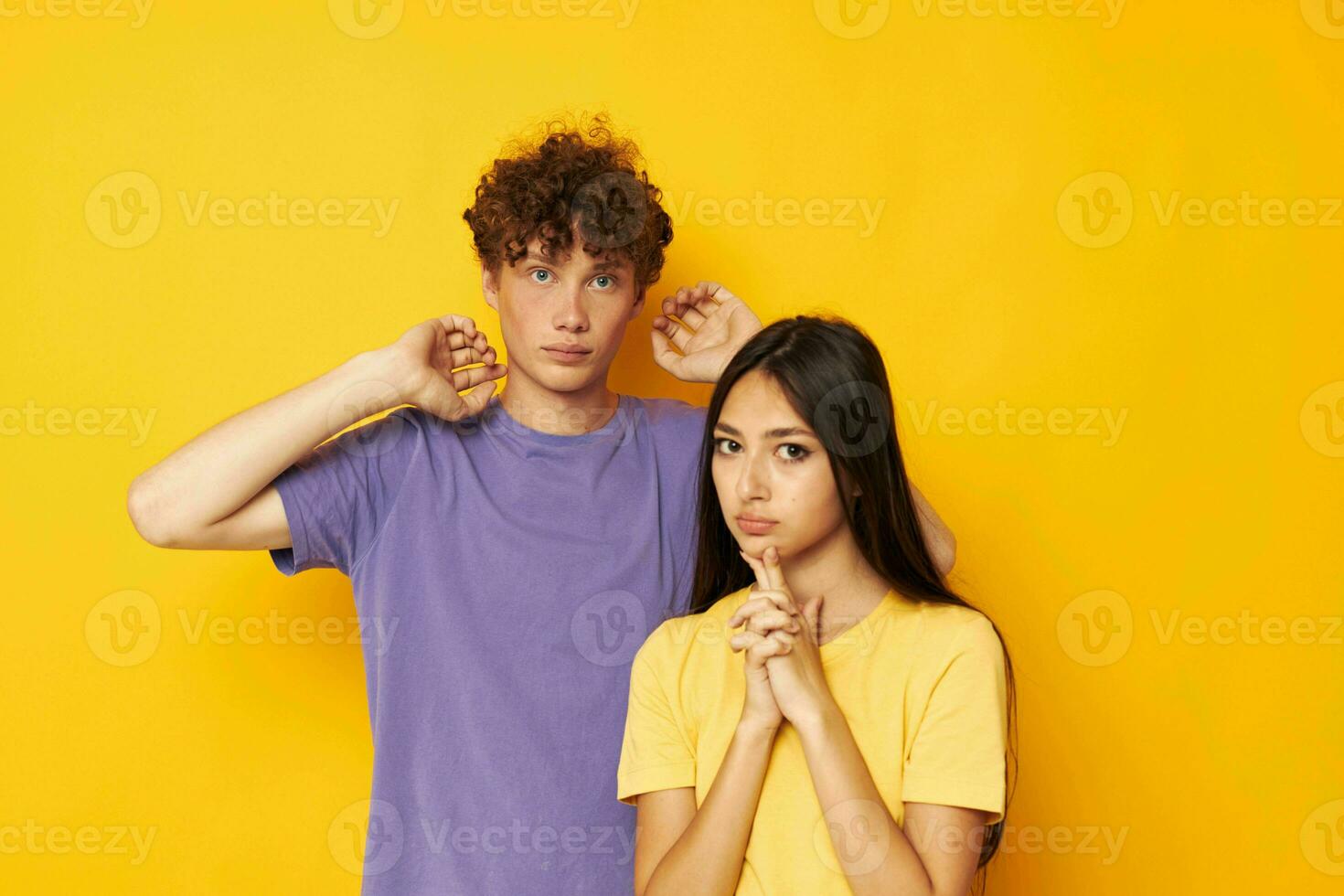 cute young couple in colorful t-shirts posing friendship fun isolated background unaltered photo