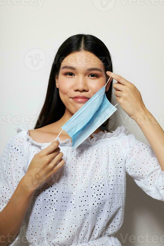 pretty brunette face shield safety close-up light background unaltered photo