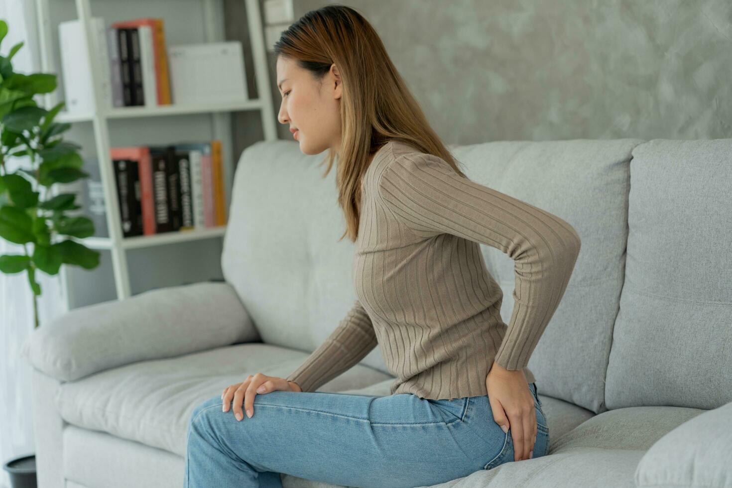 Asian Female hand holding her bottom because having abdominal pain and hemorrhoids, health care, constipation, Anatomical, suffering from pain, abdominal, bowel problem, bloody diarrhea, stomach ache photo