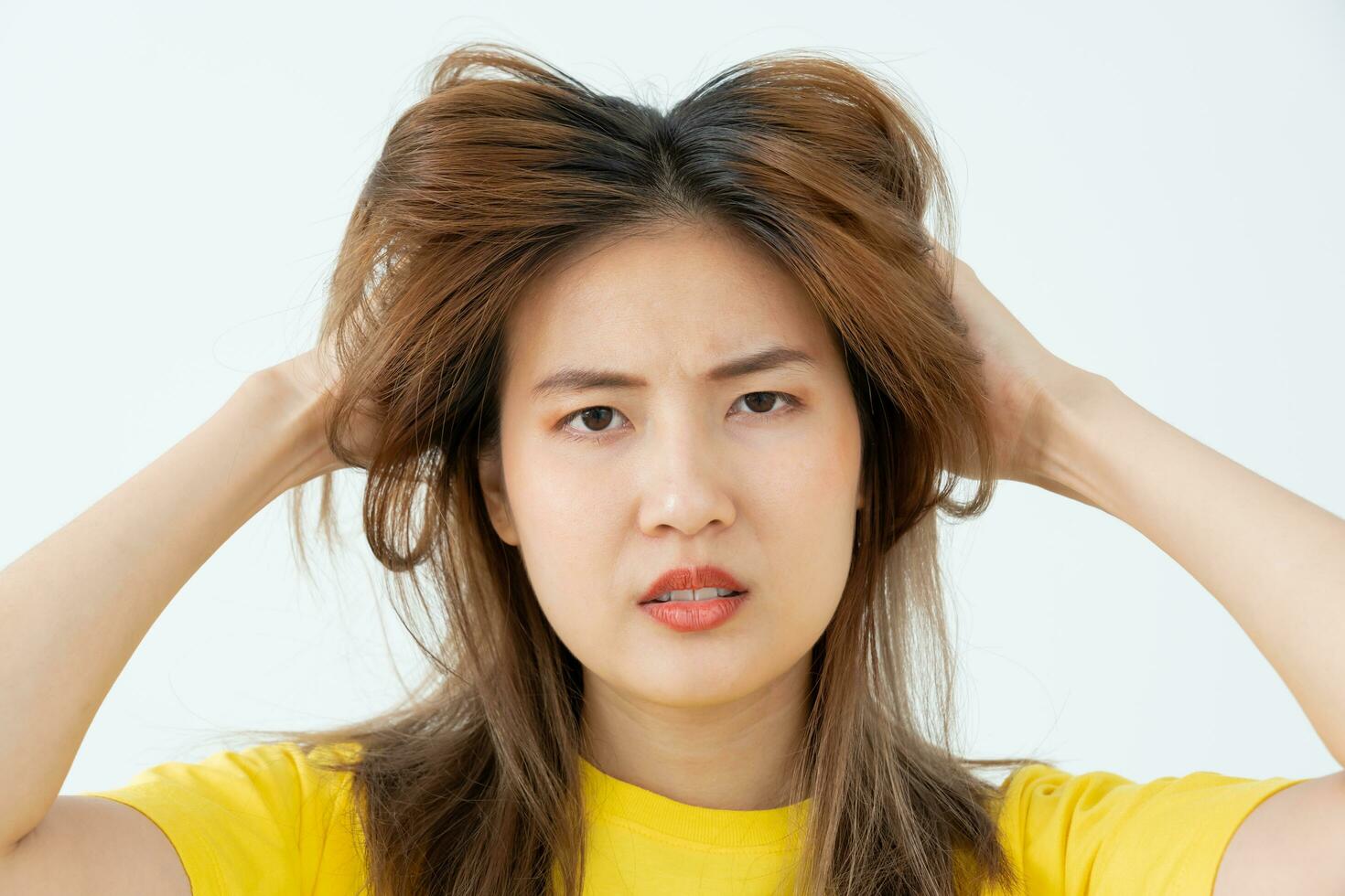 Asian woman very sad and upset looking at damaged hair, hair loss, hair thinning problem, vitamin deficiency, baldness, postpartum, biotin, zinc, menstrual or endocrine disorders, hormonal imbalance photo