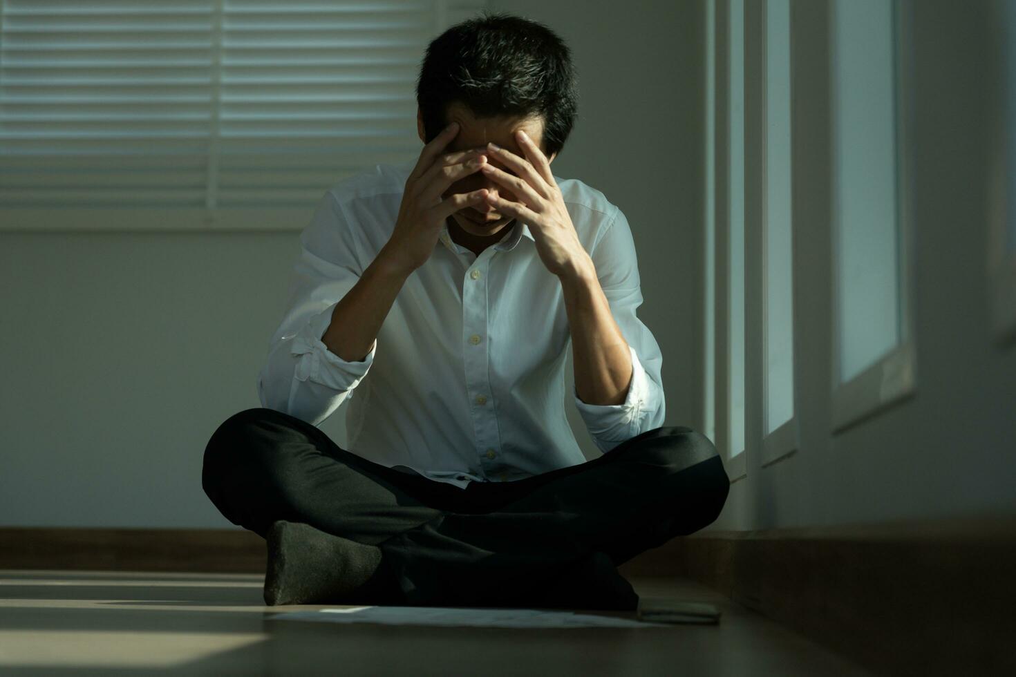 Depression and mental illness. Asian man disappoint, sad after receive bad news. Stressed boy confused with unhappy problem, arguing with girlfriend, cry and worry about unexpected work, down economy. photo