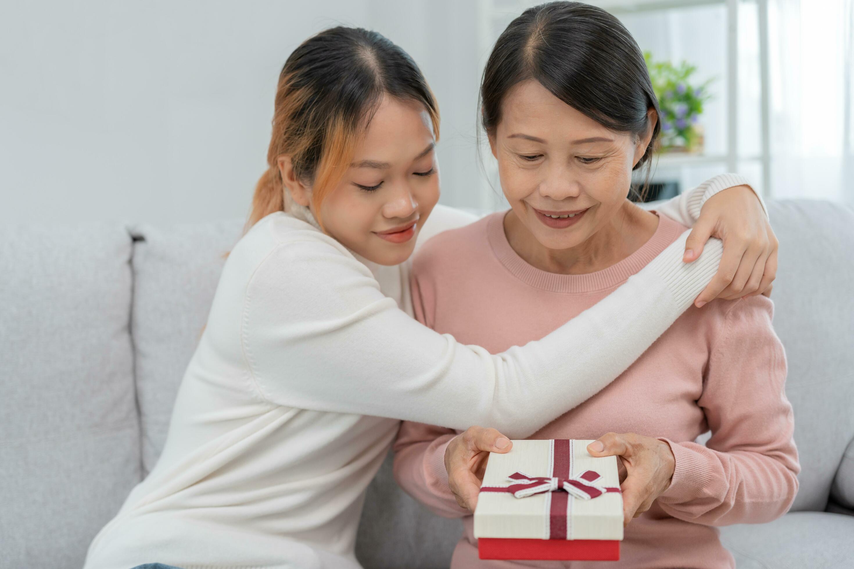 Mother day, cute asian teen girl give gift box to mature middle age mum.  Love, kiss, care, happy smile enjoy family time. celebrating special  occasion, happy birthday, happy new years, merry Christmas