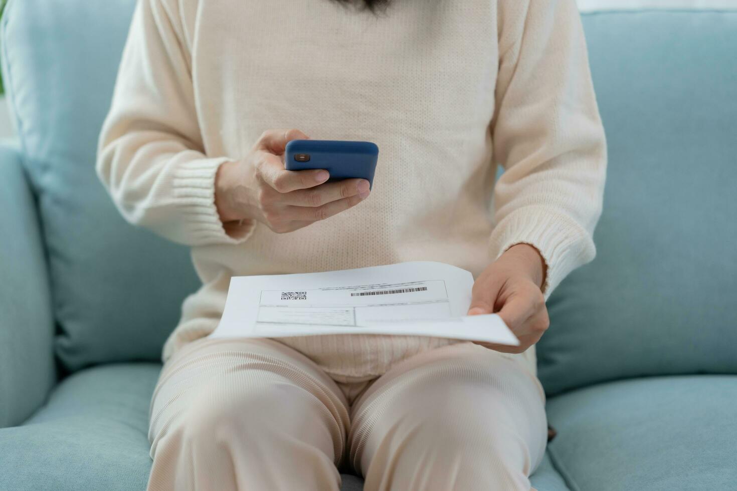 Modern woman use phone to scan barcode or QR codes to pay credit card bill after receive document invoice. payment, receive, paying electricity, digital payments without money, technology, scannin photo