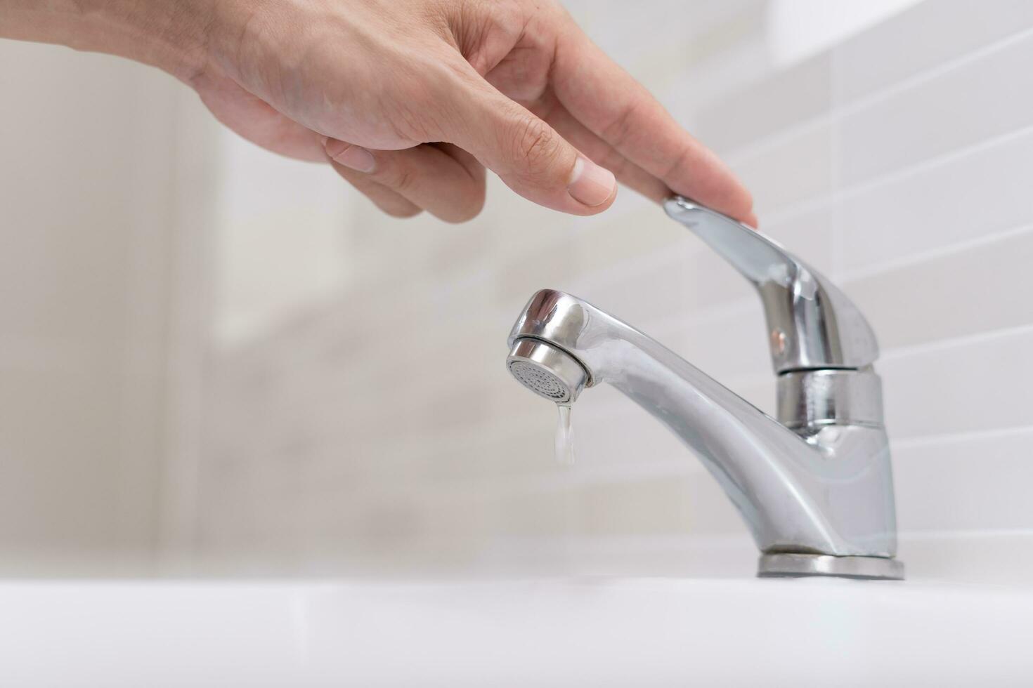 Save water. Volunteer keeps turning off the running water in the bathroom to protect environment. Greening planet, reduce global warming, Save world, life, future, risk energy, crisis , water day. photo