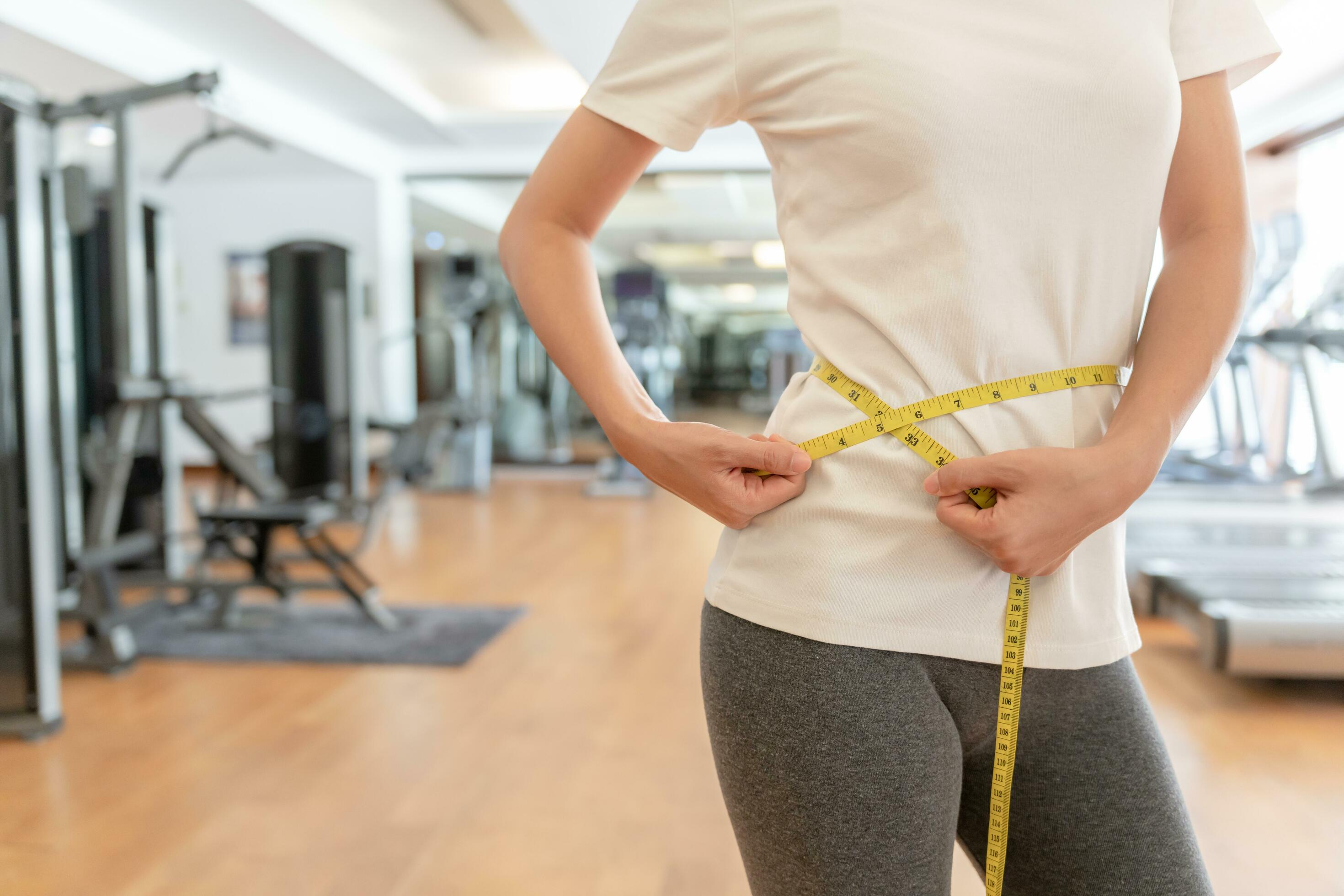 Diet and dieting. Beauty slim female body use tape measure. Woman in  exercise clothes achieves weight loss goal for healthy life, crazy about  thinness, thin waist, nutritionist. Fitness 25025259 Stock Photo at