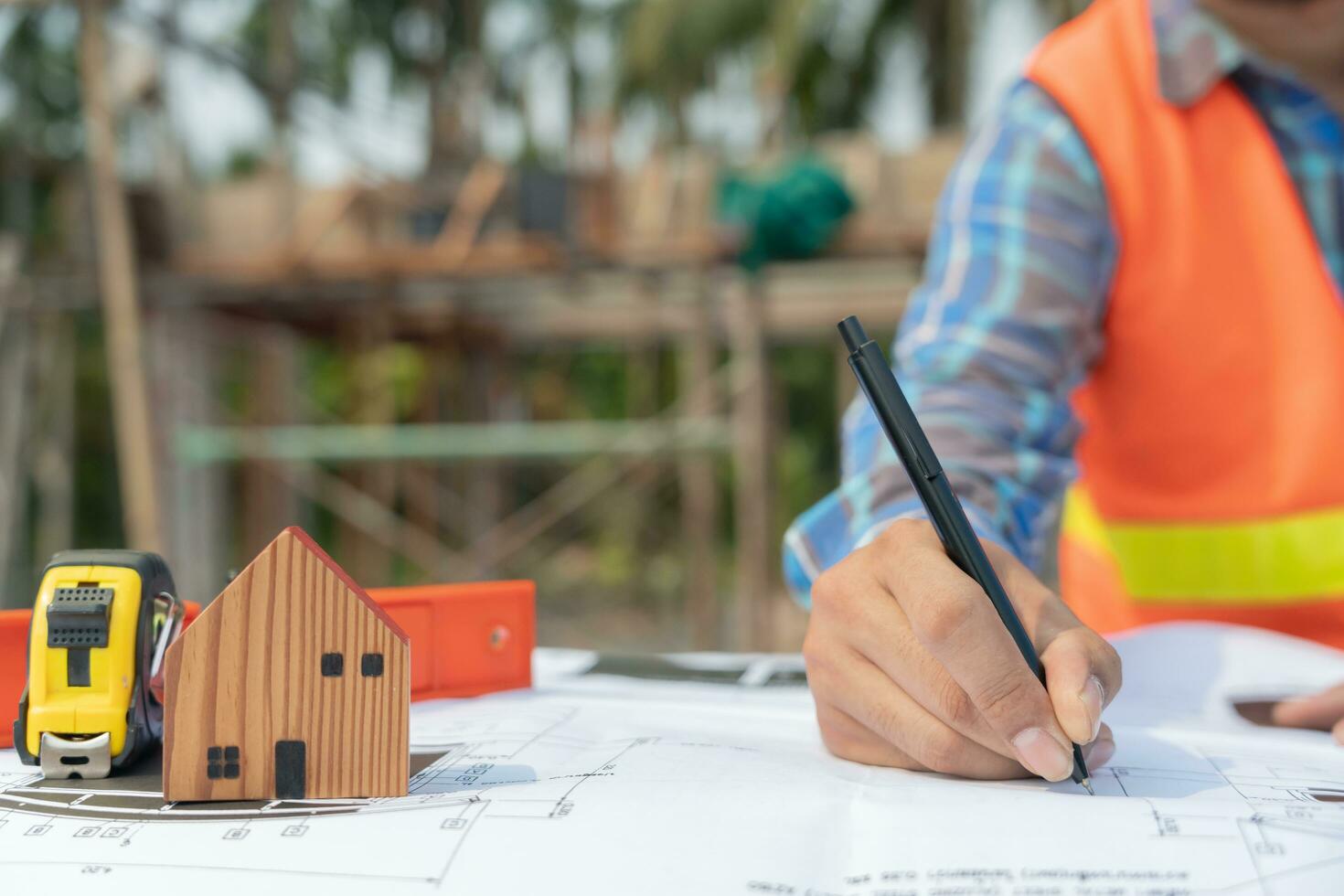 Engineers use laptops and check the blueprint. Contractor review drawing before start project civil. Prepare construction project planning concept. photo