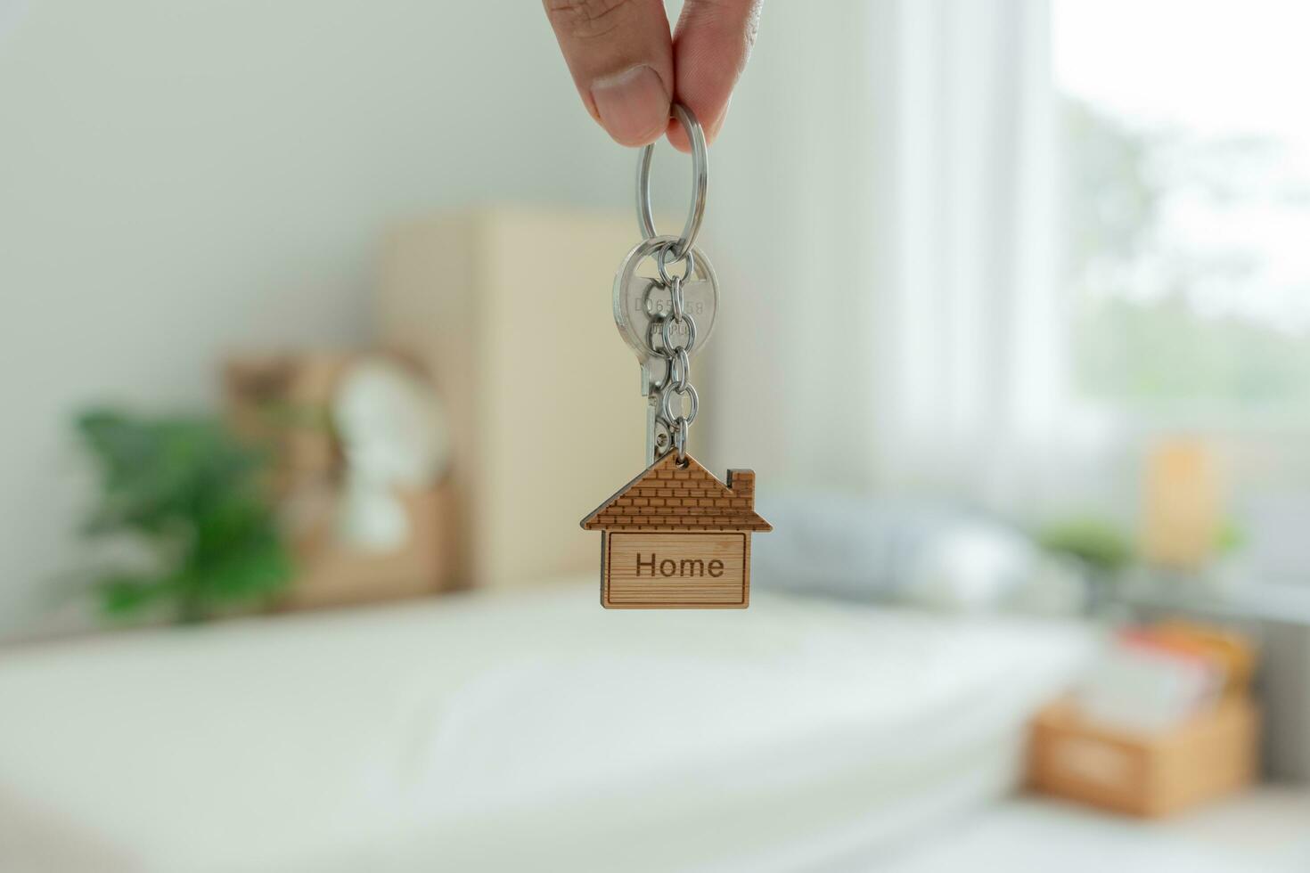 Moving house, relocation. Man hold key house keychain in new apartment. move in new home. Buy or rent real estate. flat tenancy, leasehold property, new landlord, investment, dwelling, loan, mortgage. photo