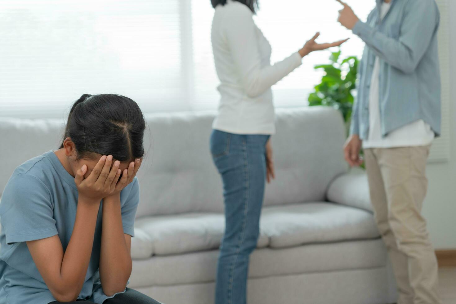 problem in family. daughter use hands cover your face and feel stressed from the parents quarrel. child is have mental problem. quarrels, violence, depression, suicide, discouragement, social problem photo