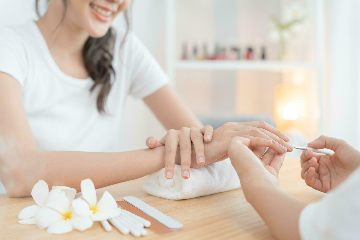Woman receive care service by professional Beautician Manicure at spa centre. Nail beauty salon use nail file for Glazing treatment. manicurist make nail customer to beautiful. body care spa treatment photo