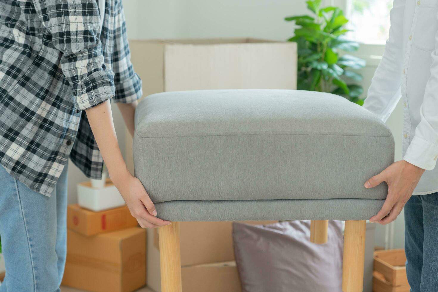 Moving house, relocation. Couple help set and move furniture for new apartment, inside the room was a cardboard box contain personal belongings. move in the new apartment or condominium photo