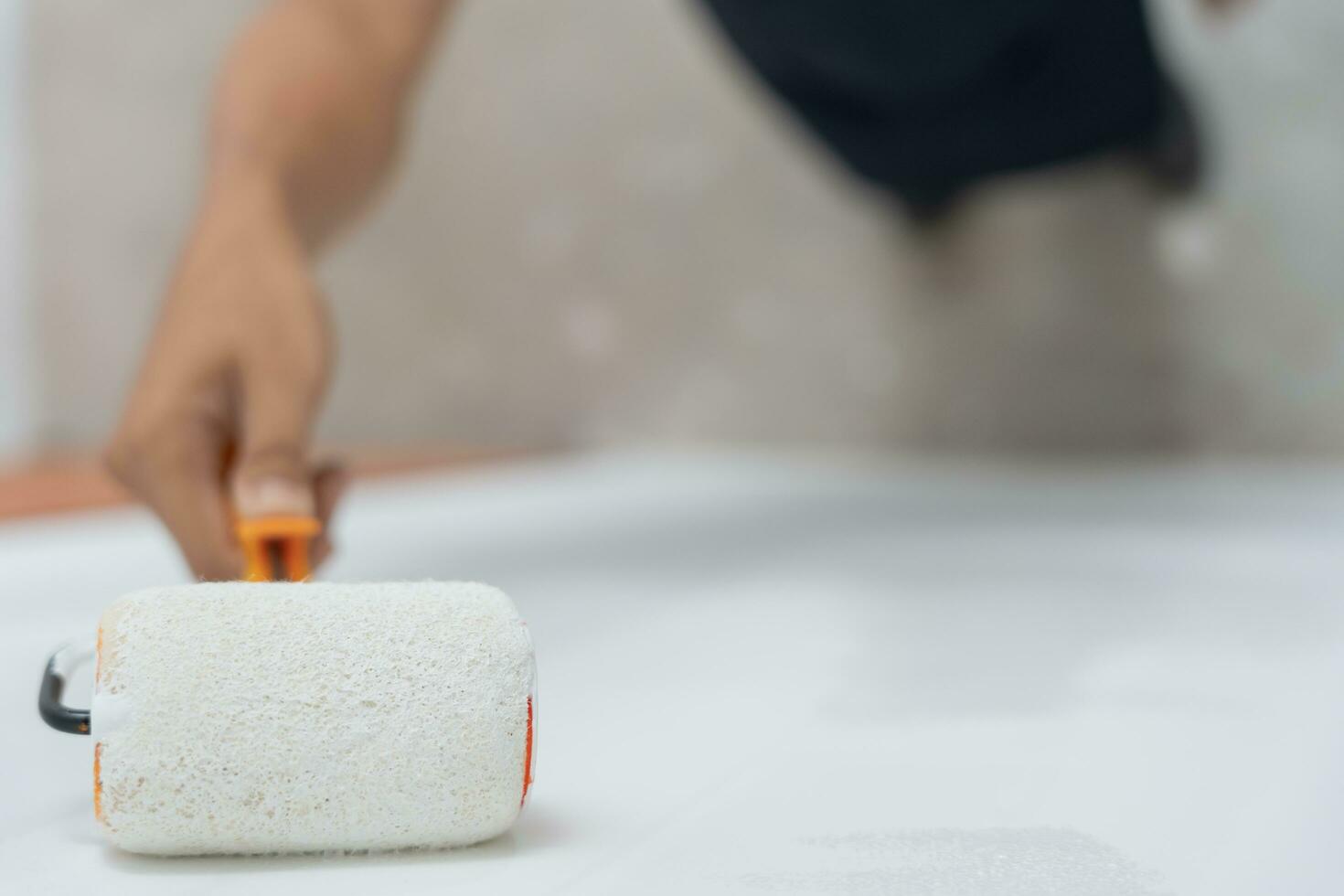 painter man, brush in hand for products to restore and paint the wall, indoor the building site of a house, wall during painting, renovation, painting, contractor, Architect, construction worker photo