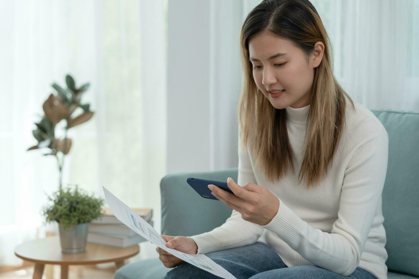 Modern woman use phone to scan barcode or QR codes to pay credit card bill after receive document invoice. payment, receive, paying electricity, digital payments without money, technology, scanning photo