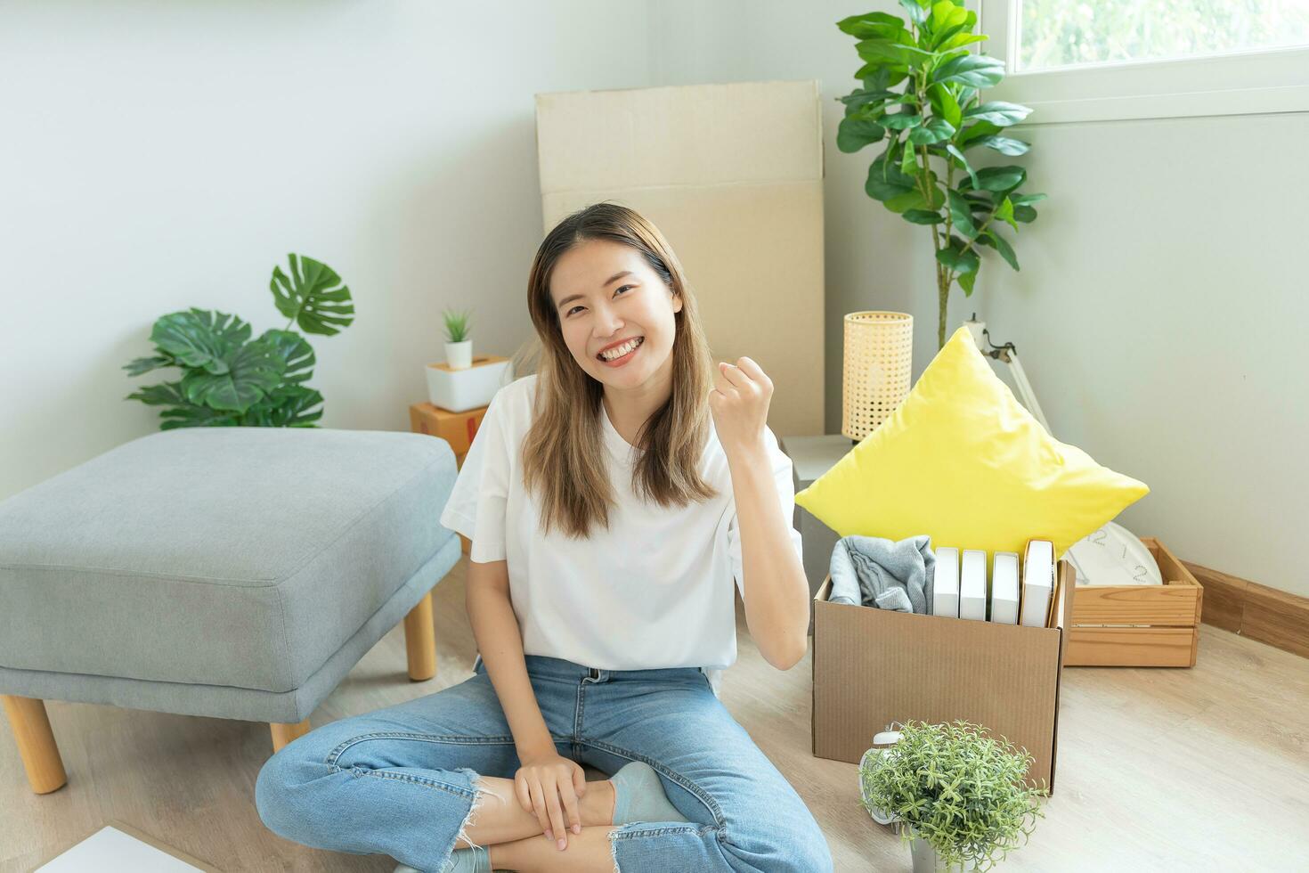 Moving house, relocation. Woman feel good and recreation on new apartment, inside the room was a cardboard box containing personal belongings and furniture. move in the house or condominium photo