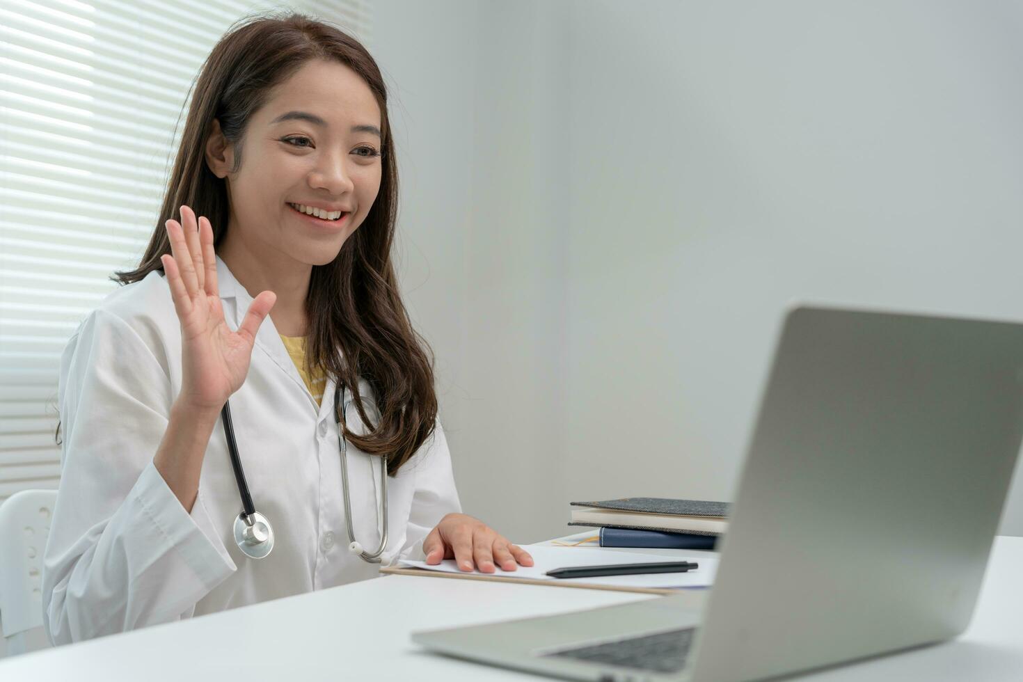 telemedical. Doctors are advising patients over the Internet by video conference. Asian doctor is treating patients through telecommunication while describing the disease . Technology for health. photo