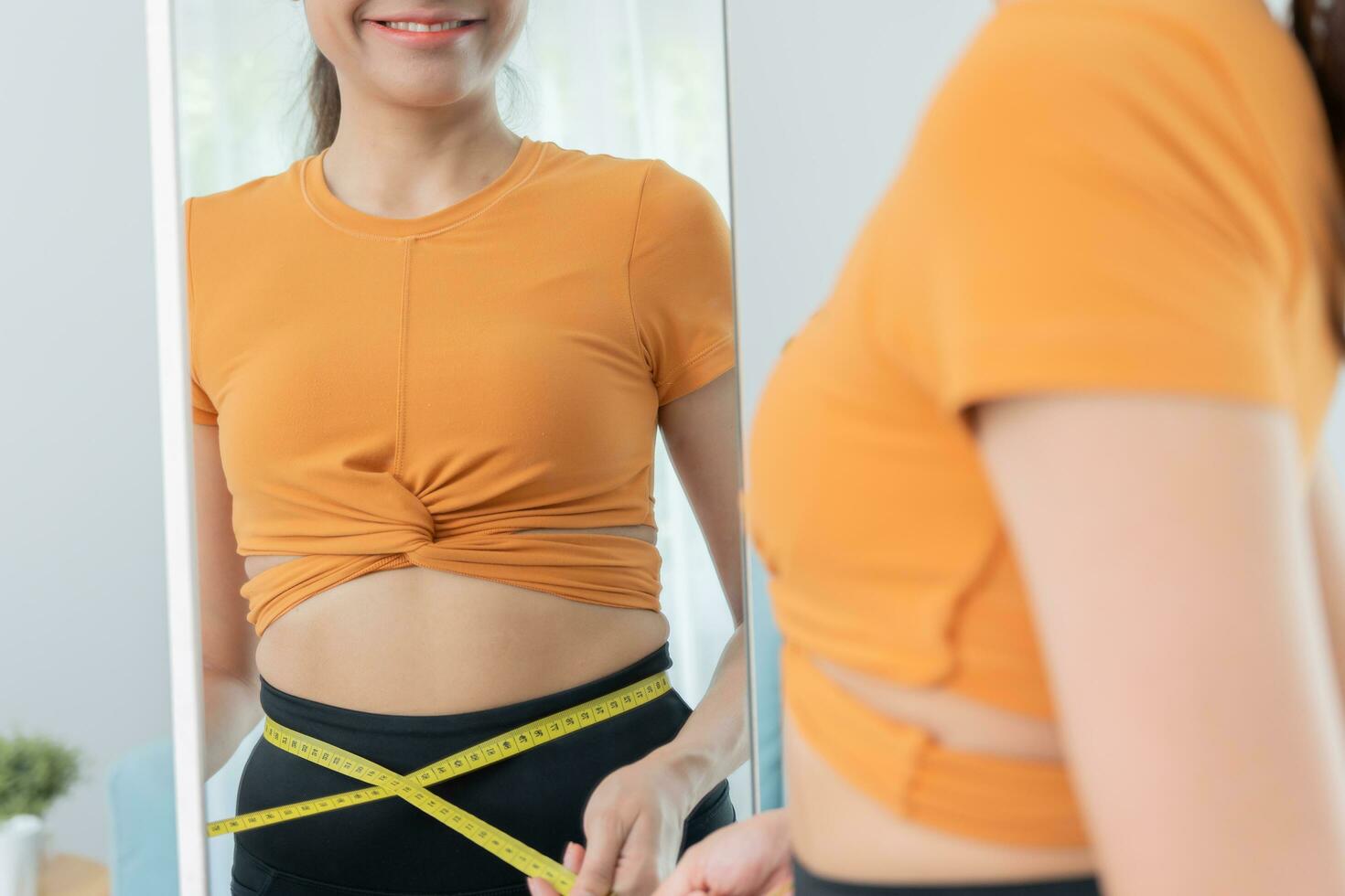 Diet and dieting. Beauty slim female body use tape measure. Woman in exercise clothes achieves weight loss goal for healthy life, crazy about thinness, thin waist, nutritionist. Fitness photo