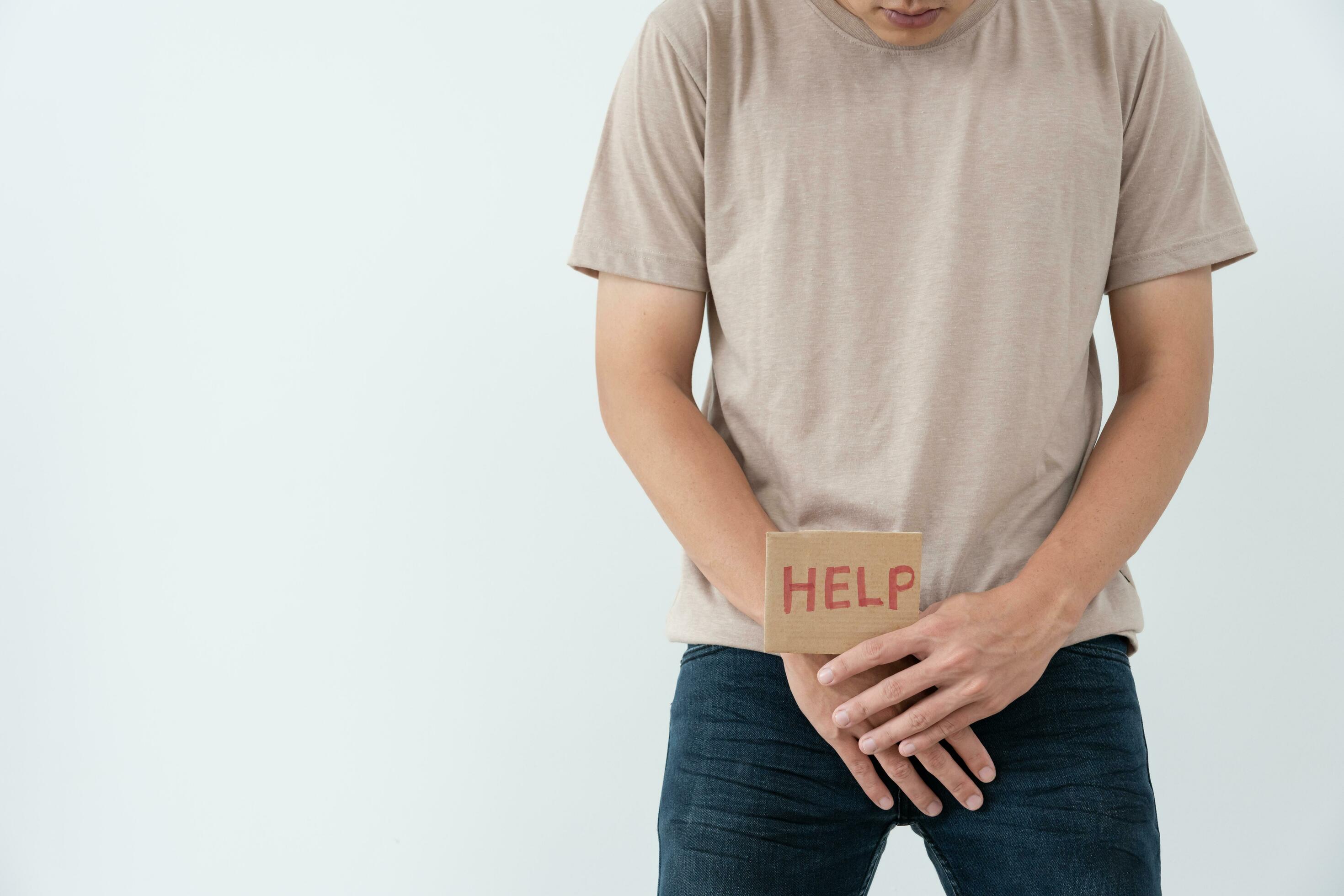 Man hold hand in front of private parts feeling from disease
