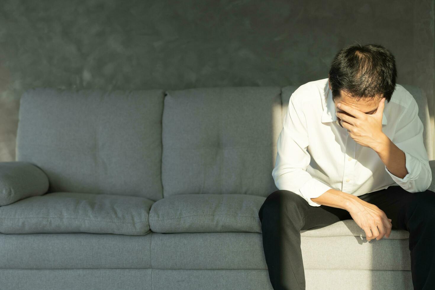 Depression and mental illness. Asian man disappoint, sad after receive bad news. Stressed boy confused with unhappy problem, arguing with girlfriend, cry and worry about unexpected work, down economy. photo