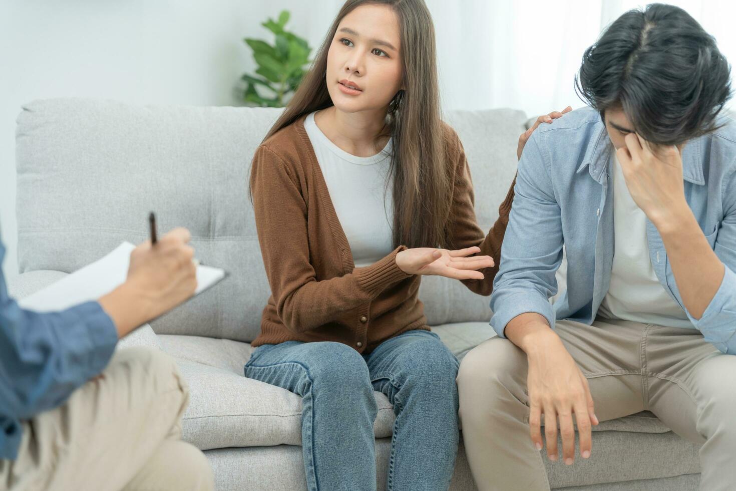 Couple support each while discussing family issues with psychiatrist. wife encourages and empathy husband suffers depression. psychological, divorce, trust, care, workplace and health issues. photo