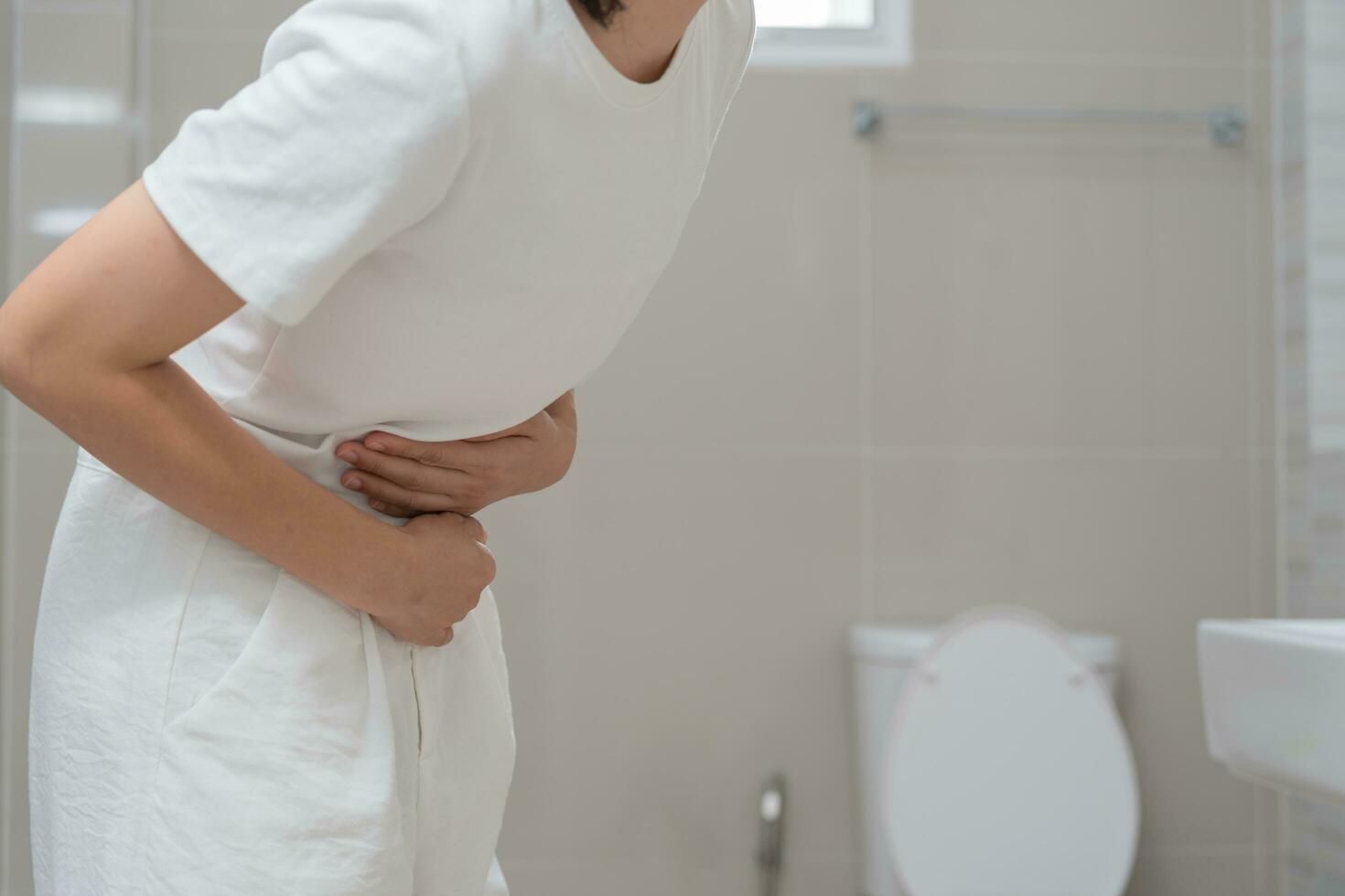 stomach ache. Asian women have abdominal pain, indigestion, gastritis, menstrual cramps, flatulence, diarrhea, distention, colon cancer, belly inflammation problem, suffer food poisoning, abdomen photo