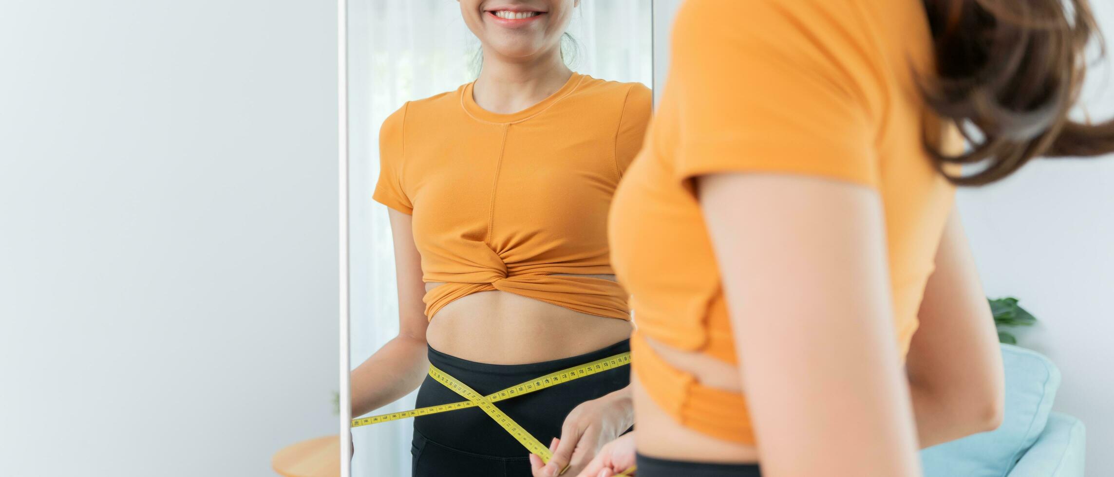 Diet and dieting. Beauty slim female body use tape measure. Woman in exercise clothes achieves weight loss goal for healthy life, crazy about thinness, thin waist, nutritionist. Fitness photo