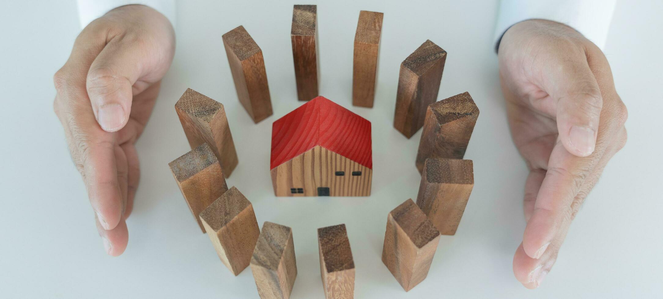 insurance with hands protect domino. Businessman hands stop dominoes falling in house crisis. business risk control and planning and strategies to run prevent insurance businesses. photo