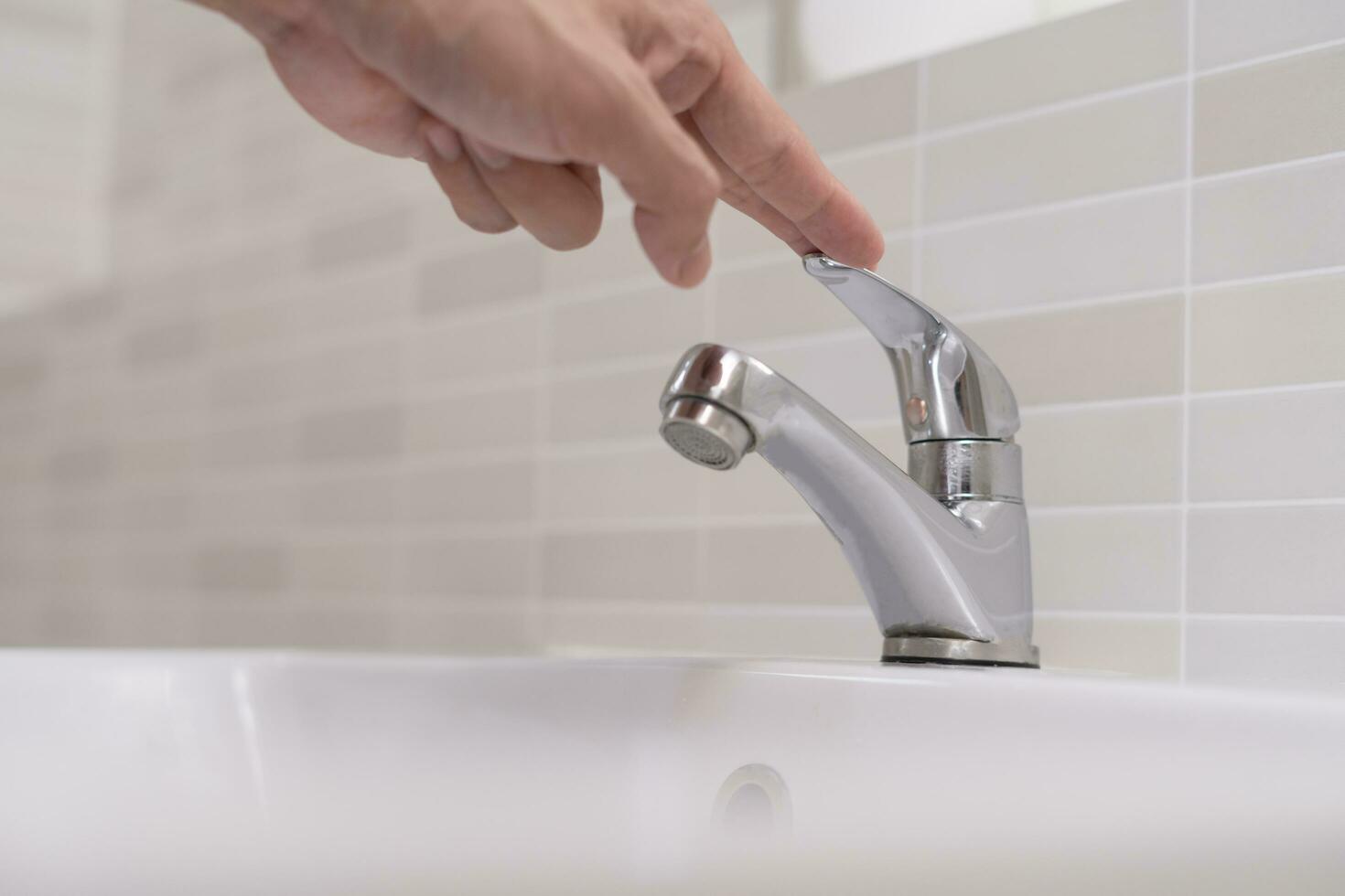 Save water. Volunteer keeps turning off the running water in the bathroom to protect environment. Greening planet, reduce global warming, Save world, life, future, risk energy, crisis , water day. photo