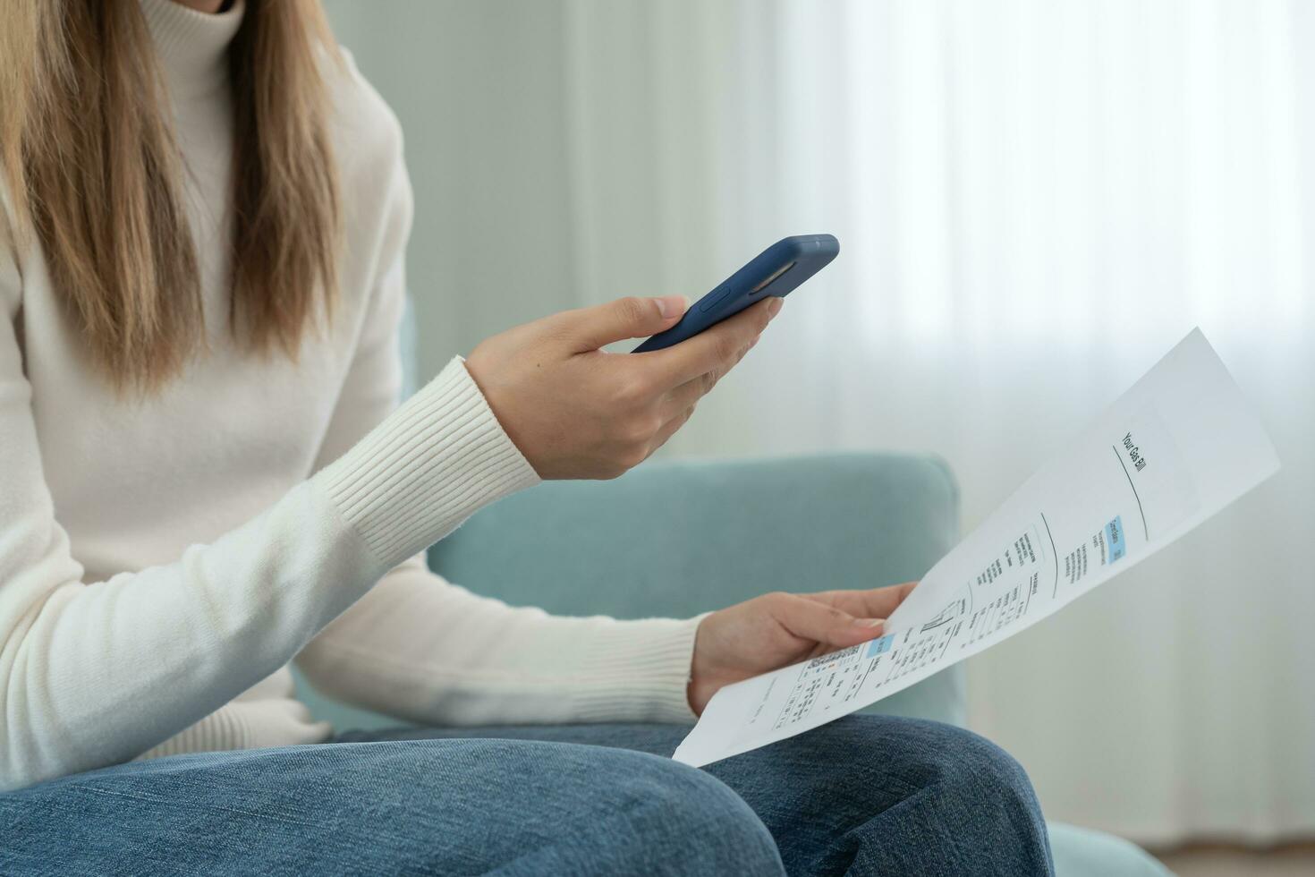 woman use phone scan barcode or QR codes to pay credit card bill after receiving document invoice. payment, receive, paying electricity, digital payments, technology, scanning, financial transactions photo