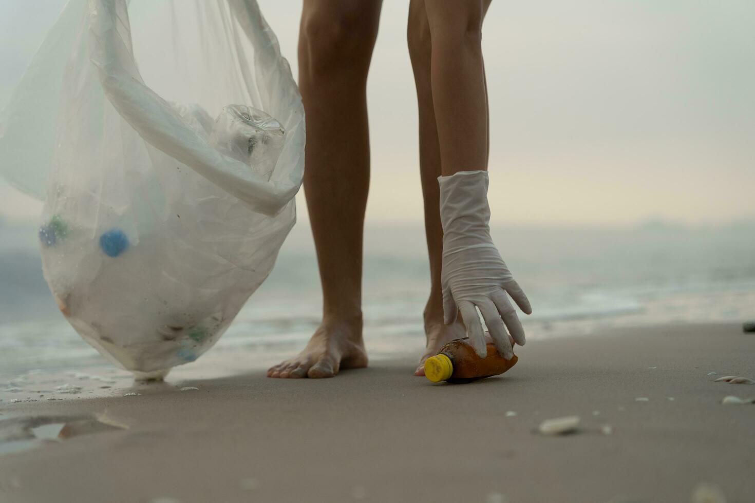 Save ocean. Volunteer pick up trash garbage at the beach and plastic bottles are difficult decompose prevent harm aquatic life. Earth, Environment, Greening planet, reduce global warming, Save world photo