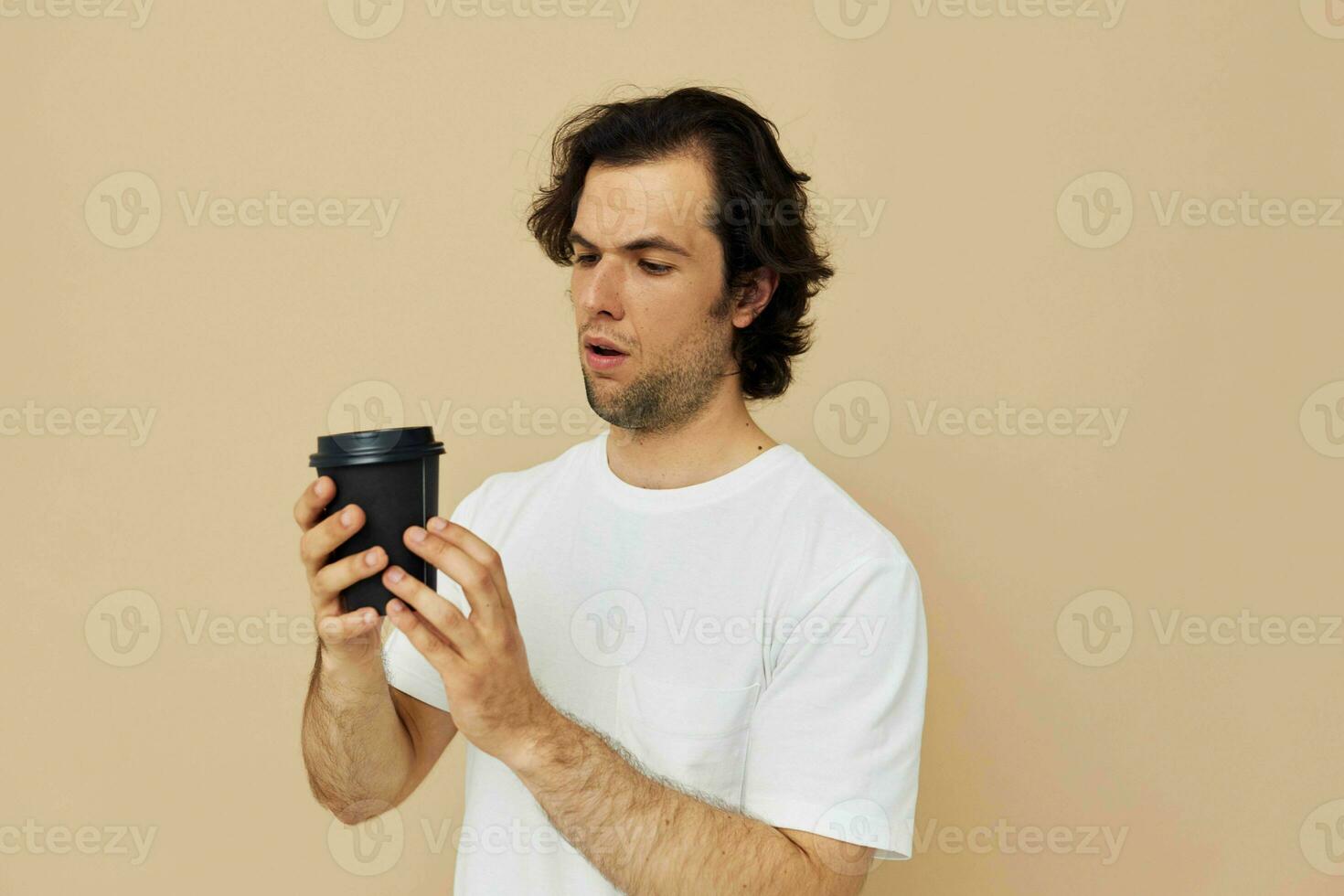 handsome man with a black glass in a white t-shirt isolated background photo