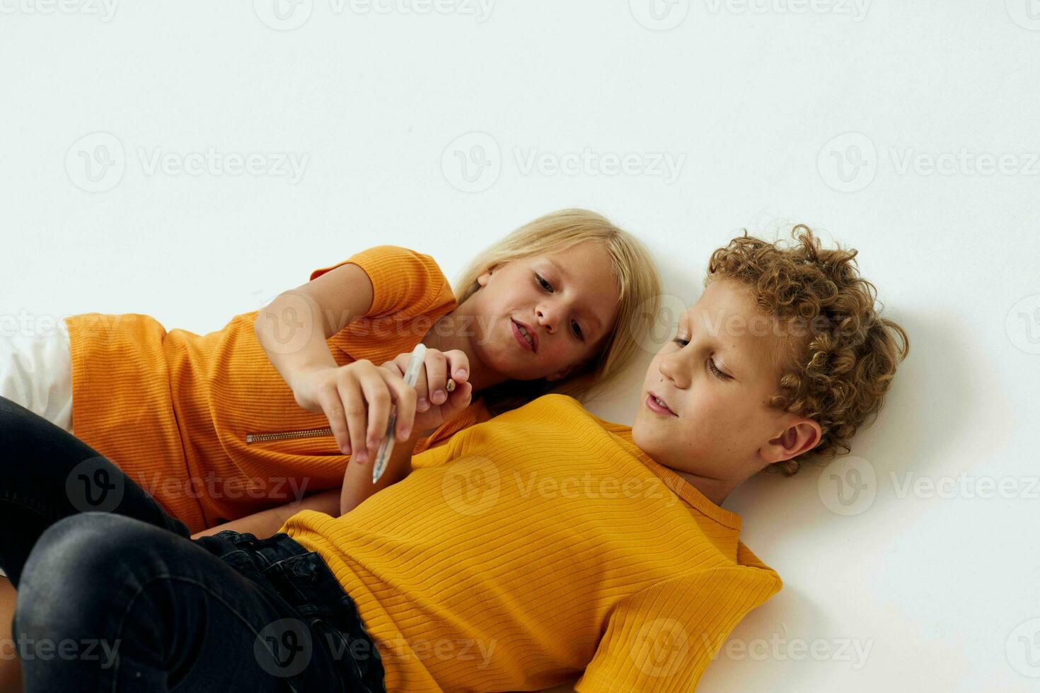 Small children emotions drawing together notepad and pencils isolated background unaltered photo