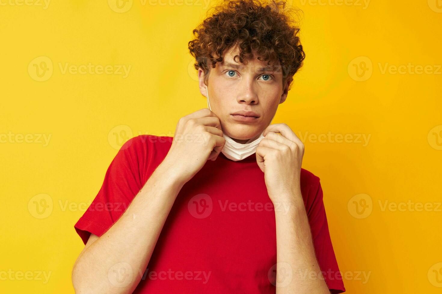 guy with red curly hair in a red t-shirt medical mask protection Lifestyle unaltered photo