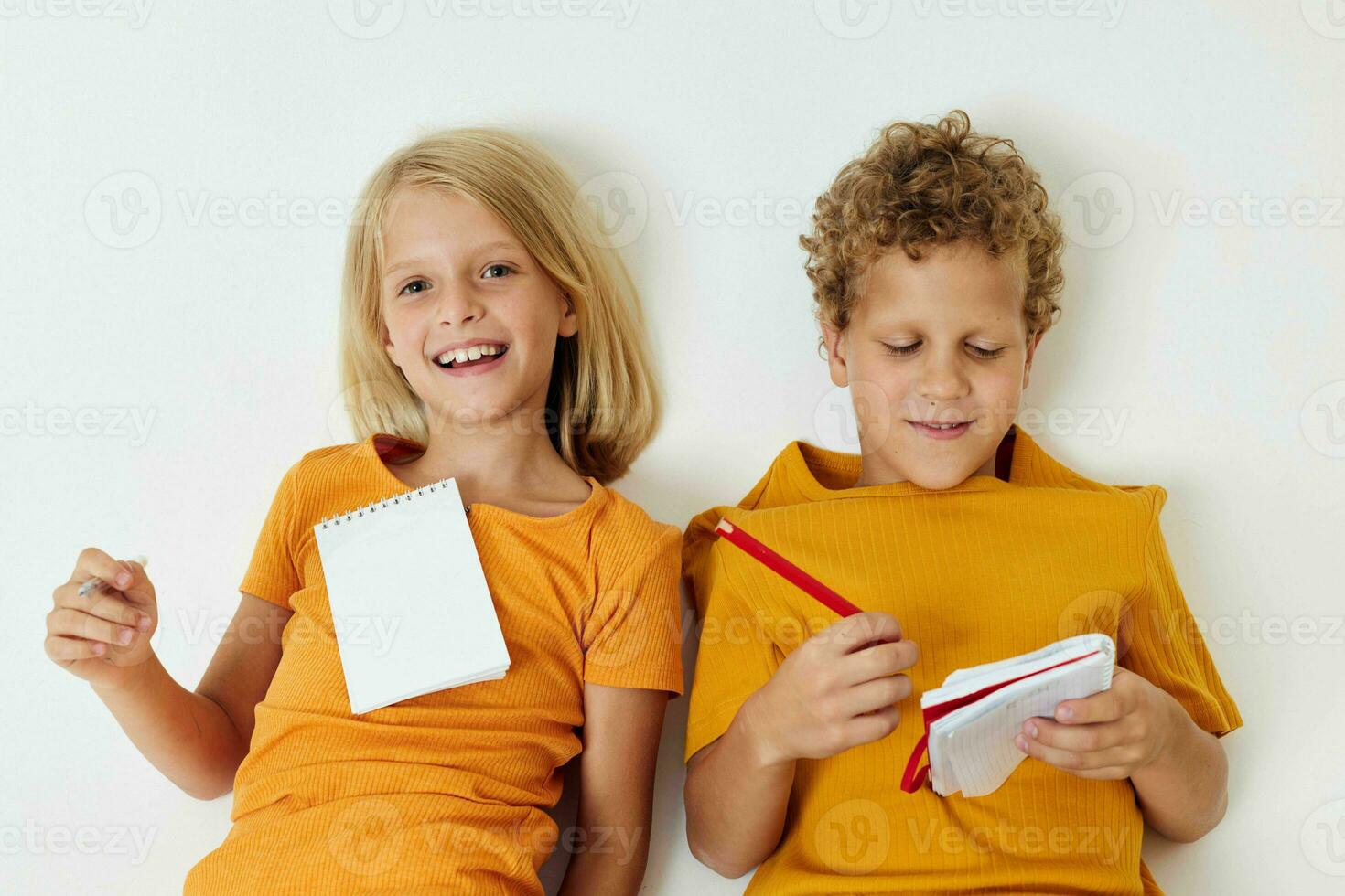 Cute preschool kids drawing fun games with notepad isolated background unaltered photo
