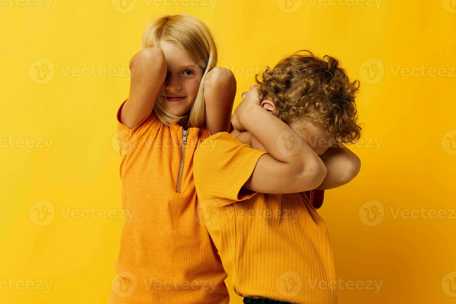 Cute stylish kids casual wear games fun together posing on colored background photo