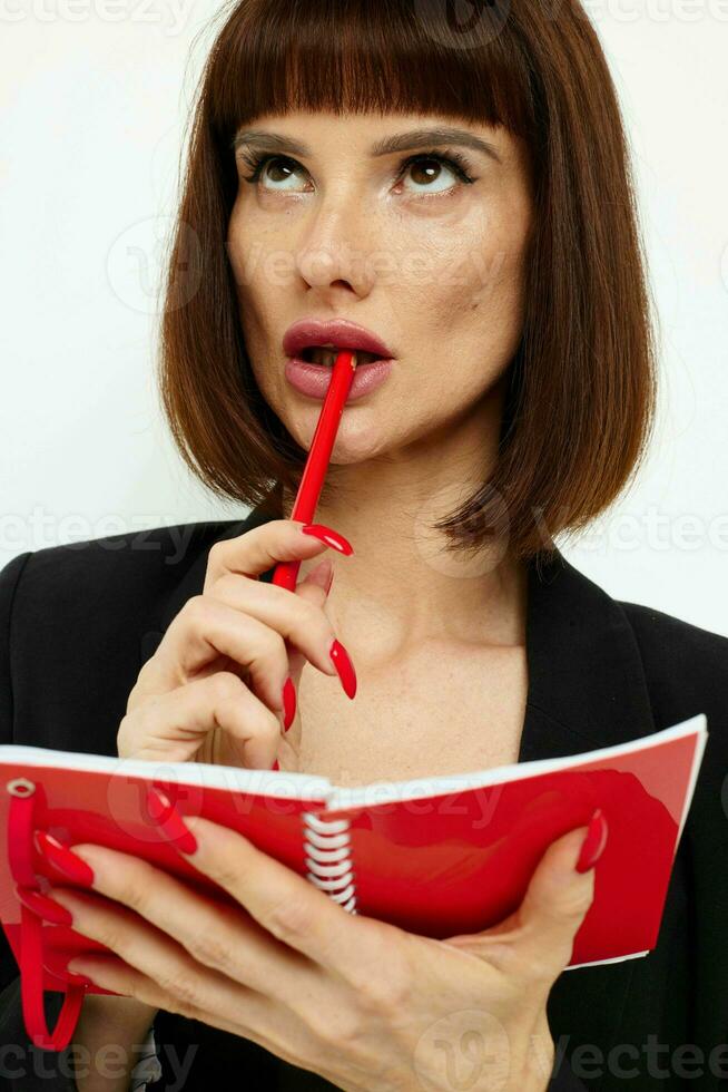 portrait of a woman writing in a notebook black jacket Lifestyle unaltered photo