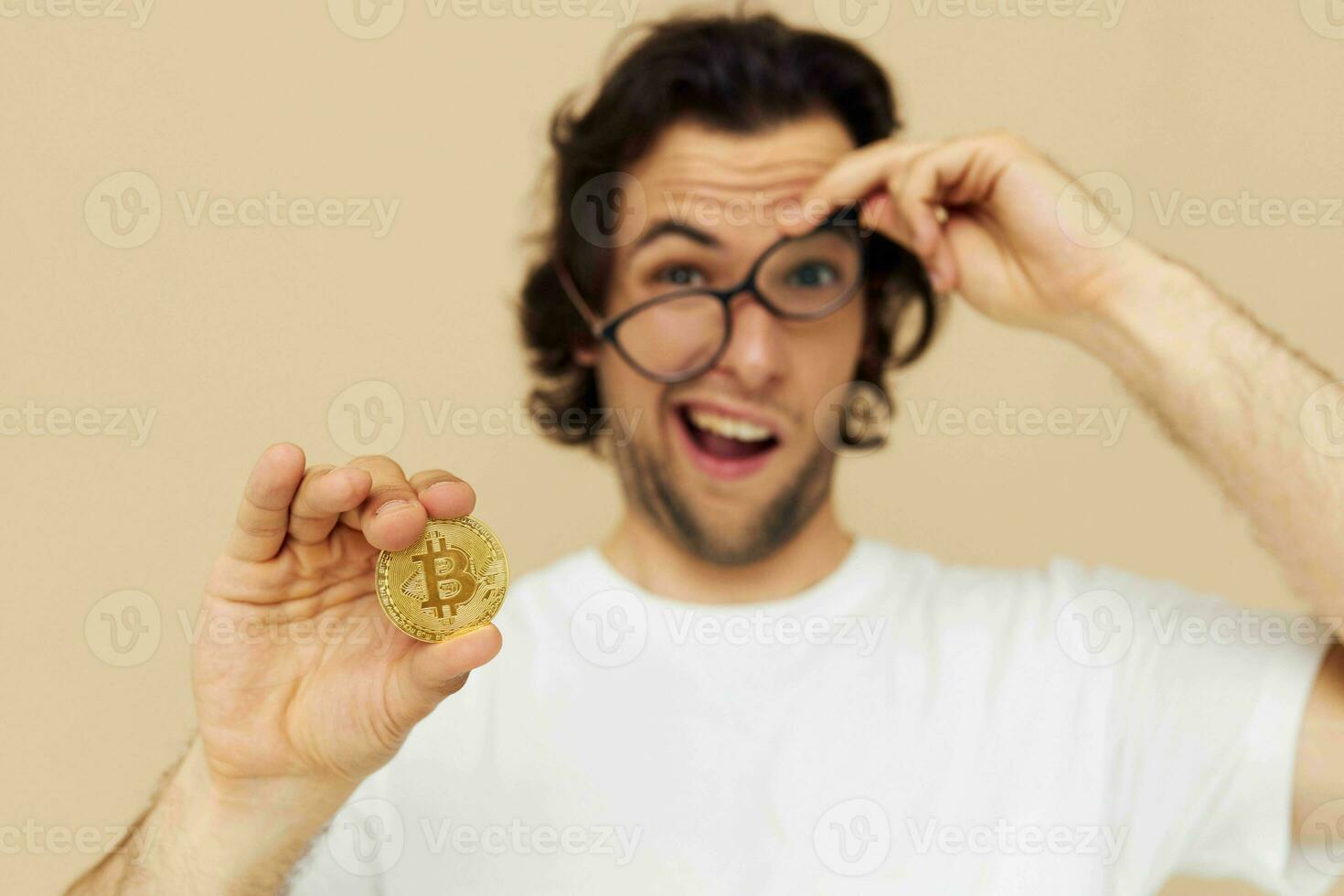 Attractive man in a white T-shirt with Bitcoin cryptocurrency isolated background photo