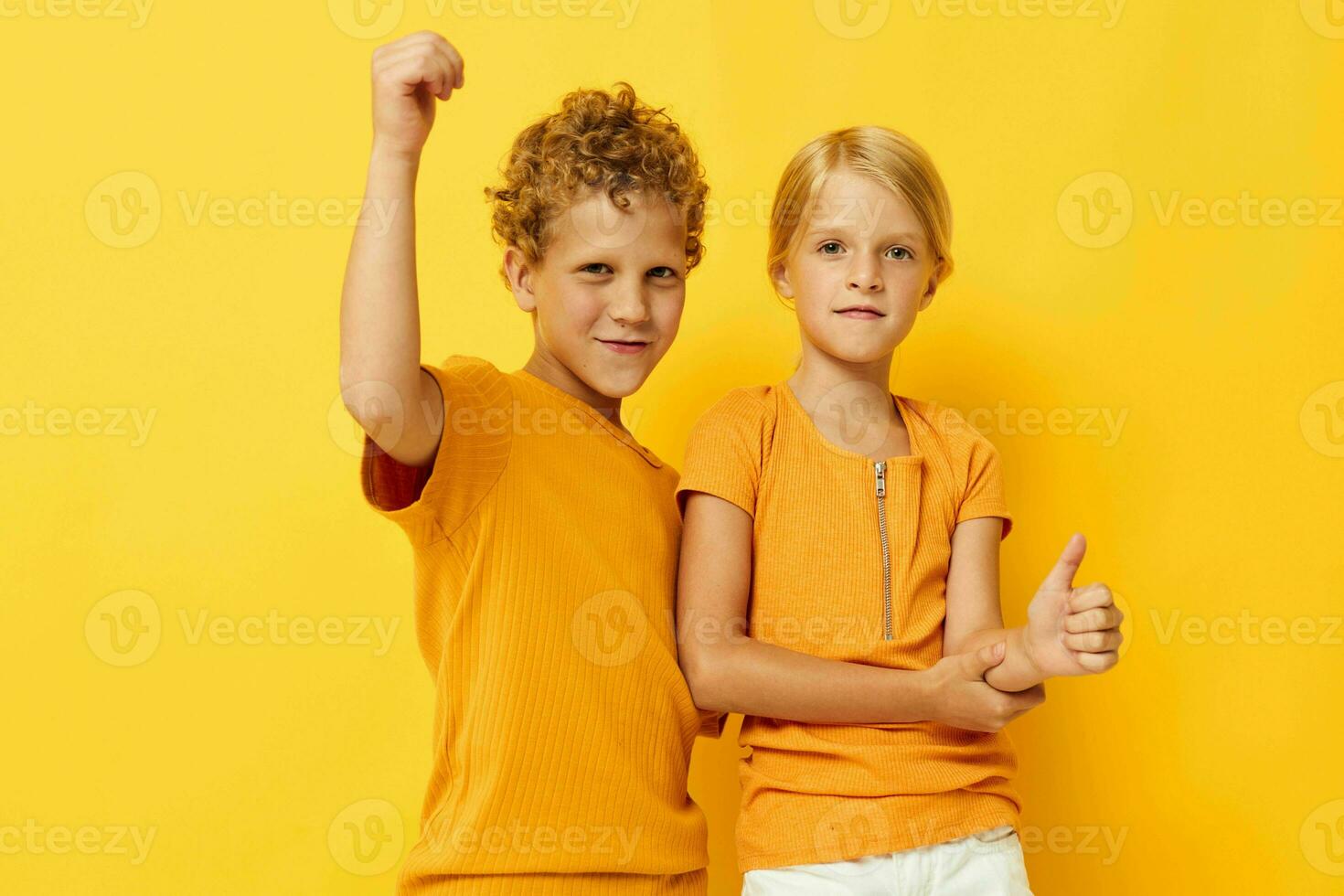 two joyful children cuddling fashion childhood entertainment on colored background unaltered photo