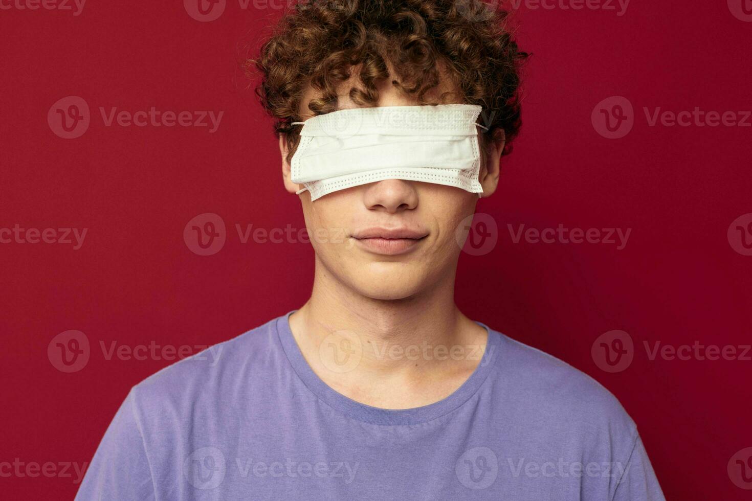 young guy medical mask protection posing red background unaltered photo