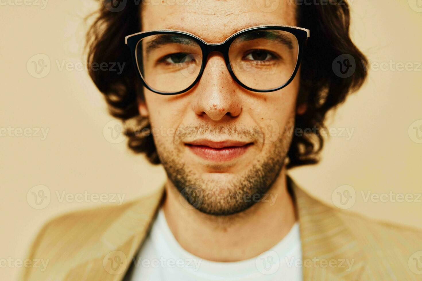 Cheerful man spectacled beige suit elegant style beige background photo