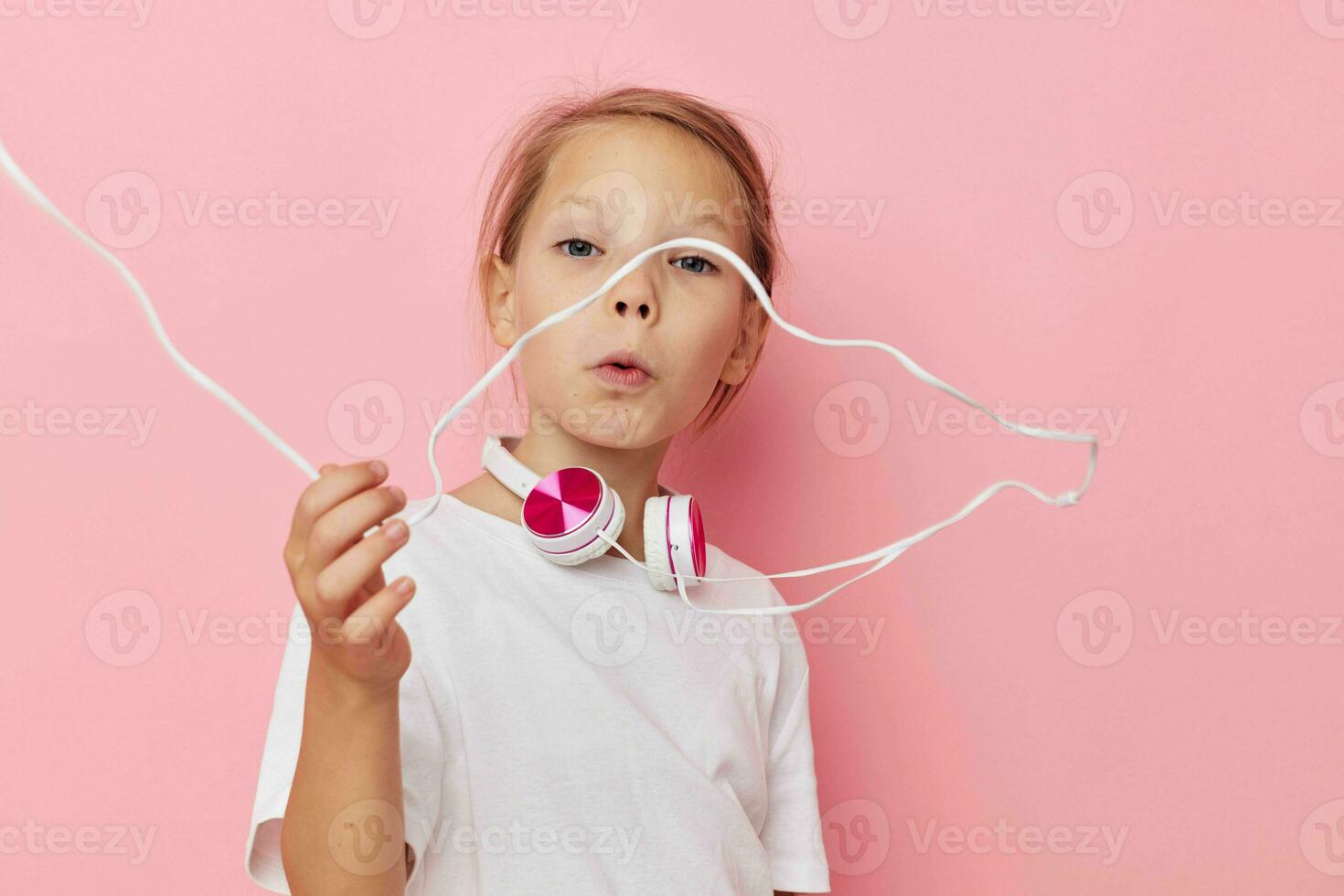 Portrait of happy smiling child girl smile posing headphones isolated background photo